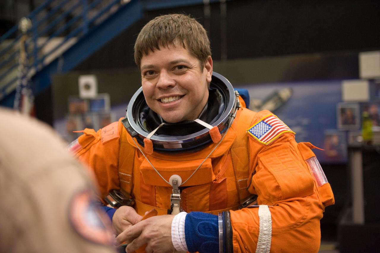 JSC2009-E-125135 (1 June 2009) --- Astronaut Robert Behnken, STS-130 mission specialist, dons a training version of his shuttle launch and entry suit in preparation for a training session in the Space Vehicle Mock-up Facility at NASA?s Johnson Space Center.
