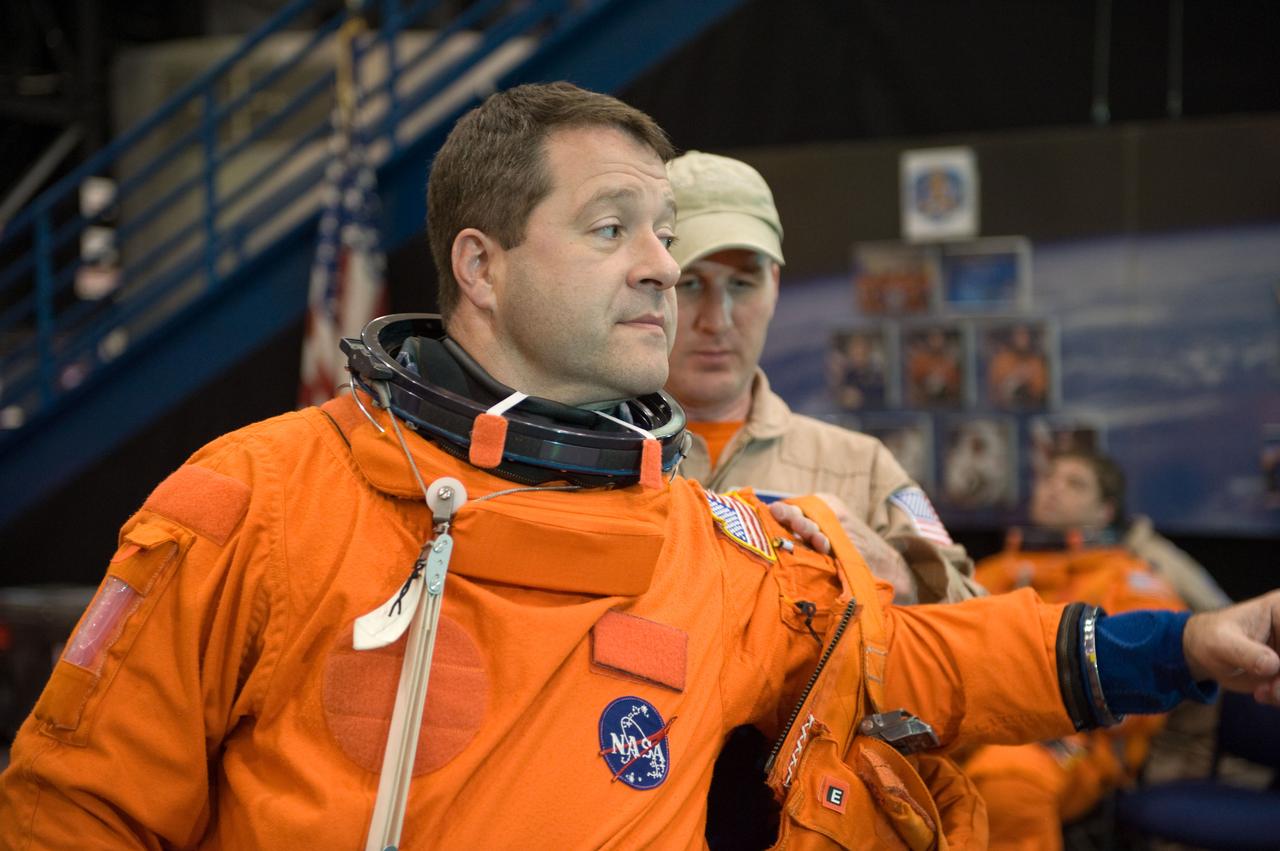 JSC2009-E-125138 (1 June 2009) --- Astronaut Nicholas Patrick, STS-130 mission specialist, gets helps with the donning of a training version of his shuttle launch and entry suit in preparation for a training session in the Space Vehicle Mock-up Facility at NASA?s Johnson Space Center.