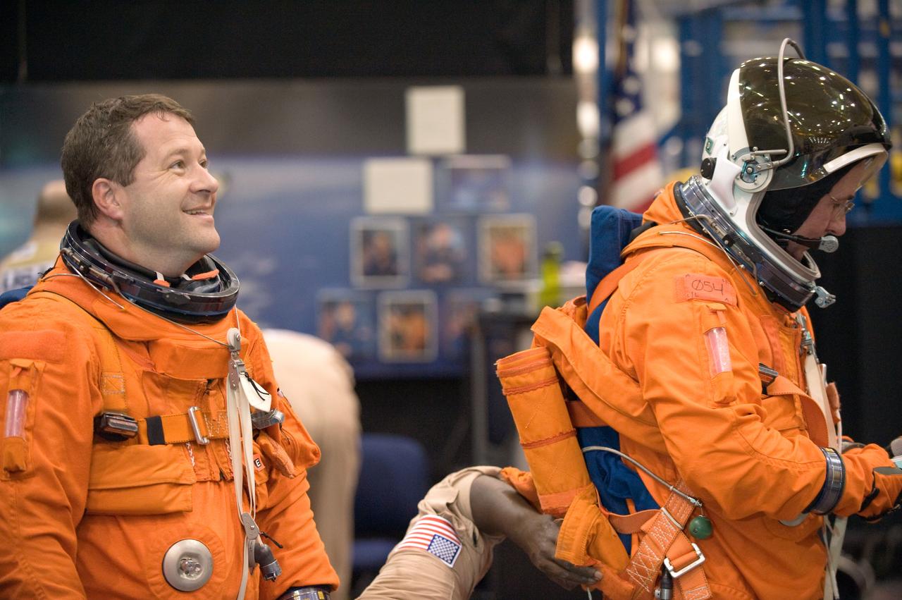 JSC2009-E-125150 (1 June 2009) --- Astronauts Nicholas Patrick (left) and Stephen Robinson, both STS-130 mission specialists, attired in training versions of their shuttle launch and entry suits, prepare for a training session in the Space Vehicle Mock-up Facility at NASA?s Johnson Space Center.