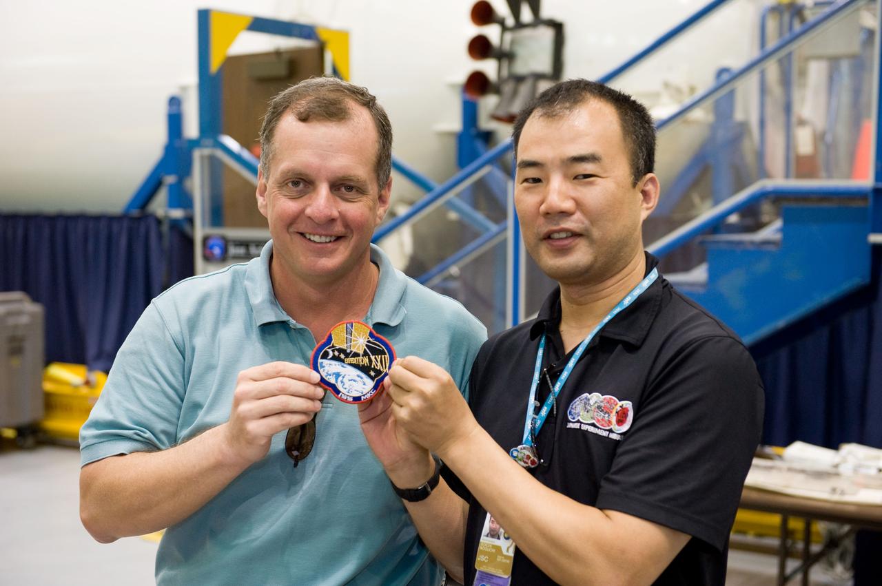 PHOTO DATE:  06-25-09 LOCATION:  Bldg 9NW SUBJECT:  JAXA veteran astronaut and Expedition 22 crew member Soichi Noguichi with JAXA's two new astronaut candidates Takuya Onishi & Kimiya Yui  PHOTOGRAPHER:  James Blair