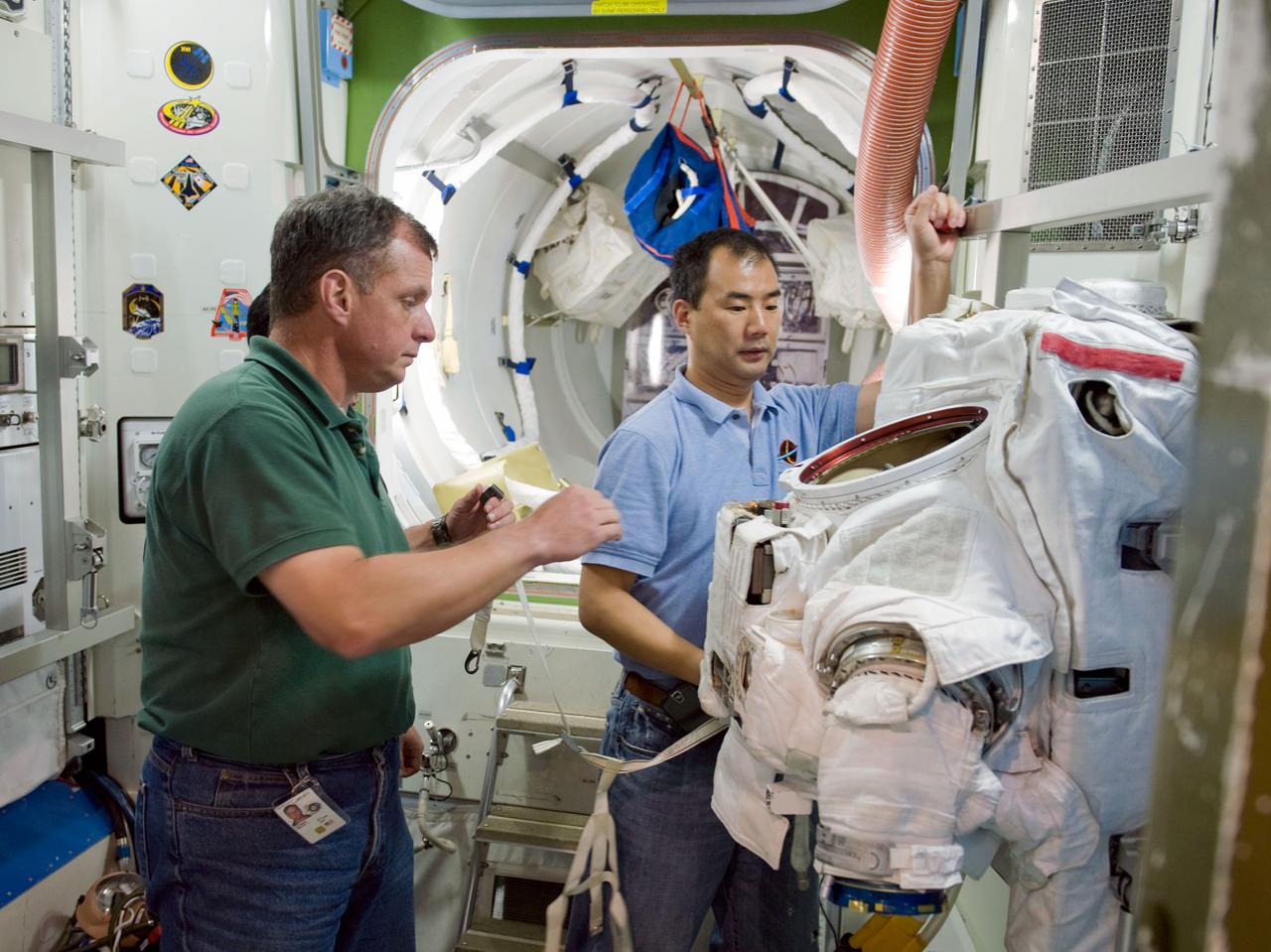 PHOTO DATE:  07-01-09 LOCATION: Bldg 9NW,  ISS Airlock SUBJECT: Expedition 22 crew memberTJ Creamerand   and JAXA astronaut Soichi Noguchi and Expedition 28 crew member Satoshi Furukawa during ISS EVA P/P training in ISS mockups. PHOTOGRAPHER:  James Blair