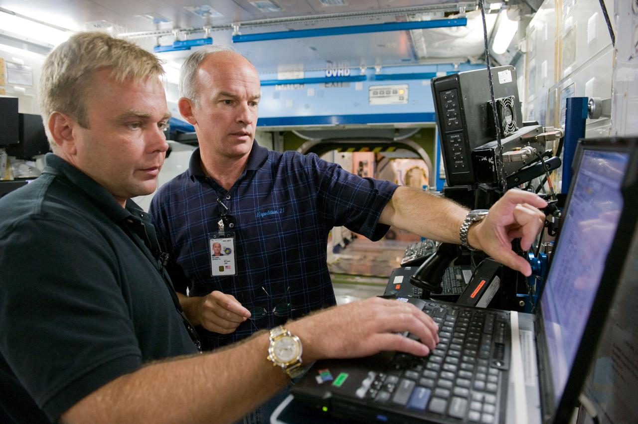 PHOTO DATE: 7-17-09 LOCATION: Bldg. 9NW - ISS Mockup SUBJECT: Expedition 21 crew members Jeff Williams and Max Suraev during ISS Routine Ops training. PHOTOGRAPHER: Lauren Harnett