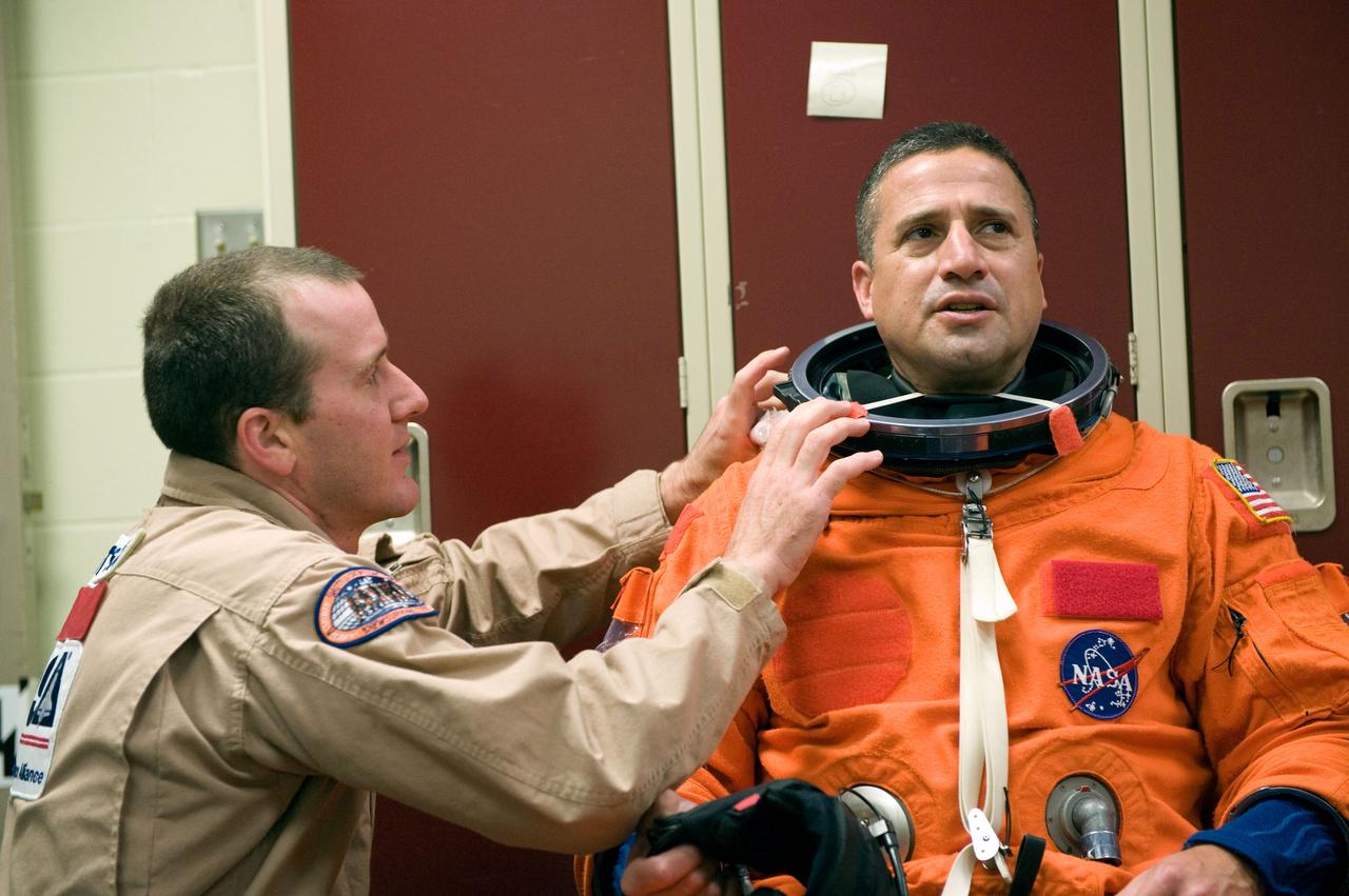 JSC2009-E-146829 (21 July 2009) --- Astronaut George Zamka, STS-130 commander, gets help with the donning of a training version of his shuttle launch and entry suit in preparation for a training session in the Space Vehicle Mock-up Facility at NASA?s Johnson Space Center.