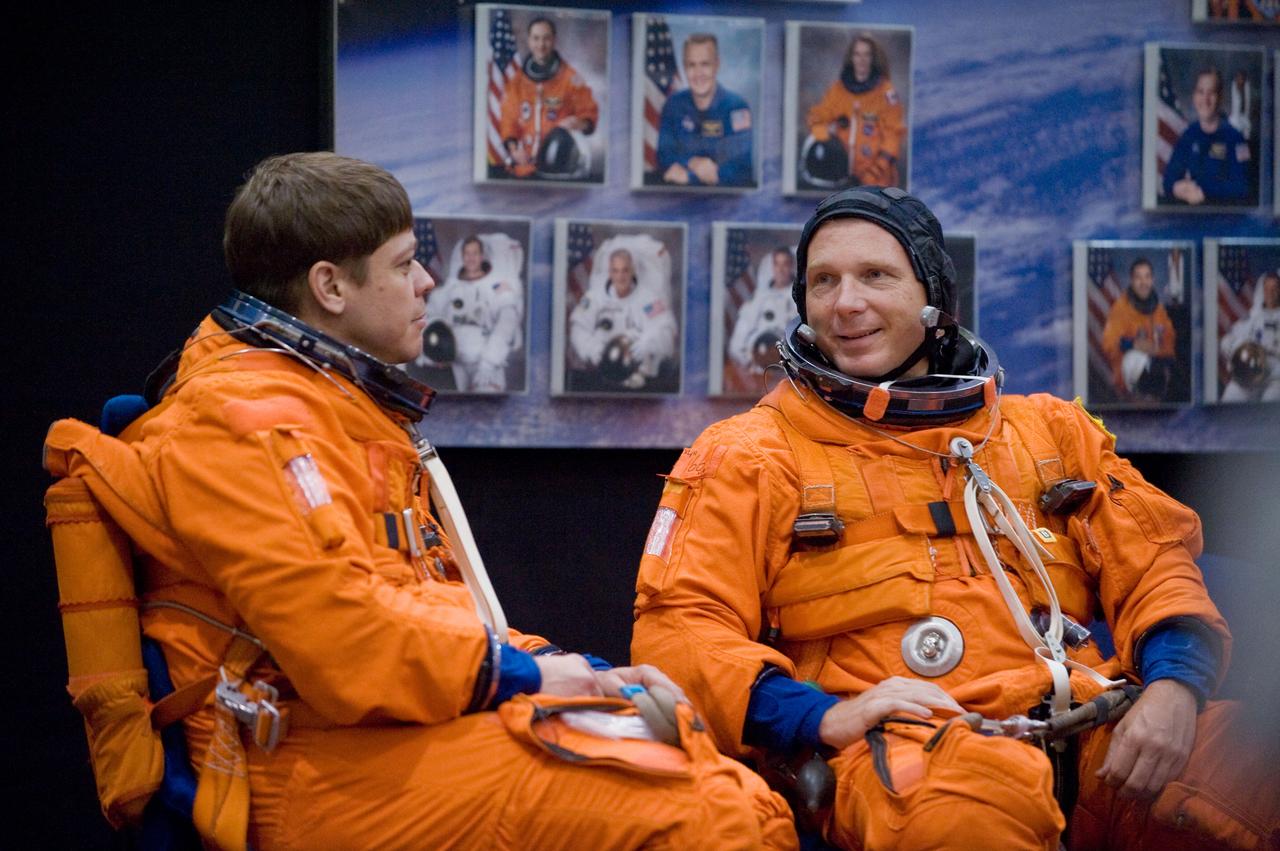 JSC2009-E-146839 (21 July 2009) --- Astronauts Robert Behnken (left), STS-130 mission specialist; and Terry Virts Jr., pilot, attired in training versions of their shuttle launch and entry suits, await the start of a training session in the Space Vehicle Mock-up Facility at NASA?s Johnson Space Center.