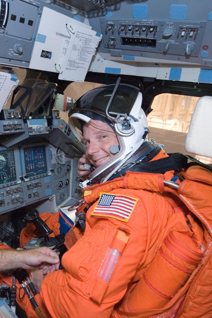 JSC2009-E-146840 (21 July 2009) --- While seated at the pilot?s station, astronaut Terry Virts Jr., STS-130 pilot, participates in a post insertion/de-orbit training session in the crew compartment trainer (CCT-2) in the Space Vehicle Mockup Facility at NASA?s Johnson Space Center. Virts is wearing a training version of his shuttle launch and entry suit.