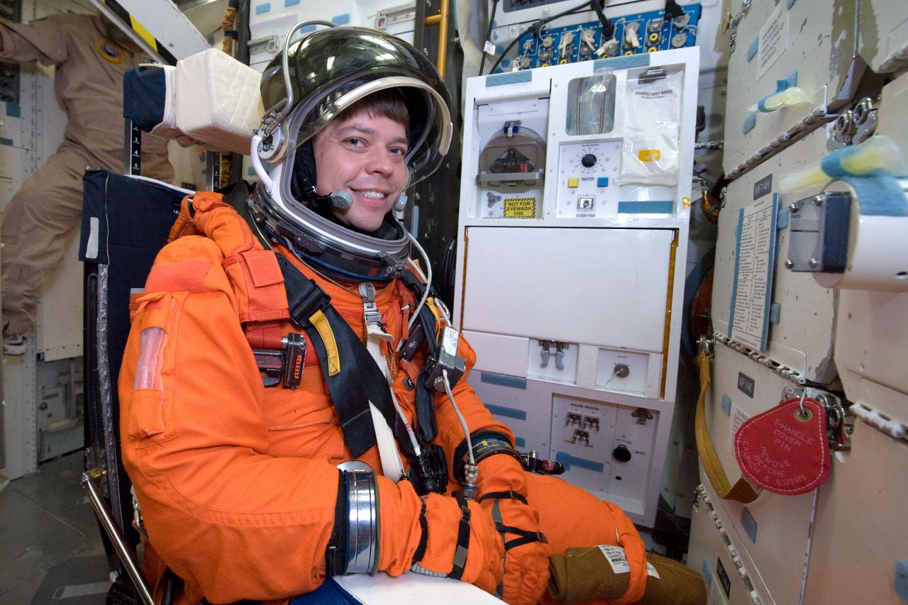 JSC2009-E-146846 (21 July 2009) --- Attired in a training version of his shuttle launch and entry suit, astronaut Robert Behnken, STS-130 mission specialist, participates in a training session on the middeck of the crew compartment trainer (CCT-2) in the Space Vehicle Mockup Facility at NASA?s Johnson Space Center.