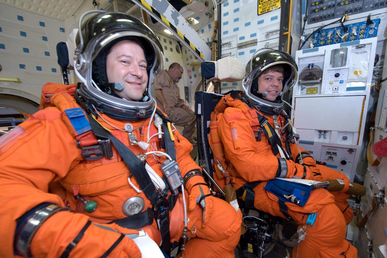 JSC2009-E-146847 (21 July 2009) --- Attired in training versions of their shuttle launch and entry suits, astronauts Nicholas Patrick (left) and Robert Behnken, both STS-130 mission specialists, participate in a training session on the middeck of the crew compartment trainer (CCT-2) in the Space Vehicle Mockup Facility at NASA?s Johnson Space Center.