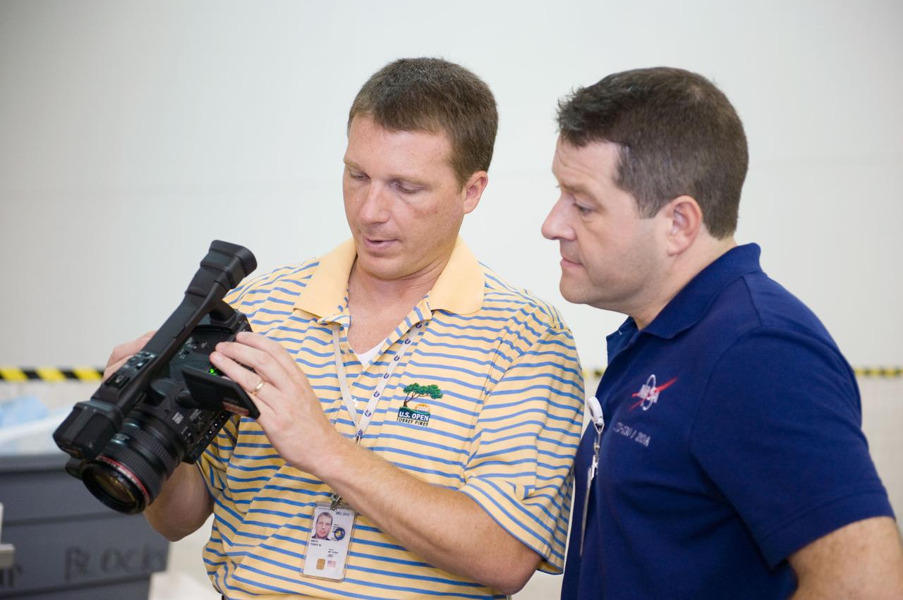 JSC2009-E-155116 (24 Aug. 2009) --- Astronauts Terry Virts Jr. (left), STS-130 pilot; and Nicholas Patrick, mission specialist, are pictured with a video camera during a training session in the Neutral Buoyancy Laboratory (NBL) near NASA's Johnson Space Center.