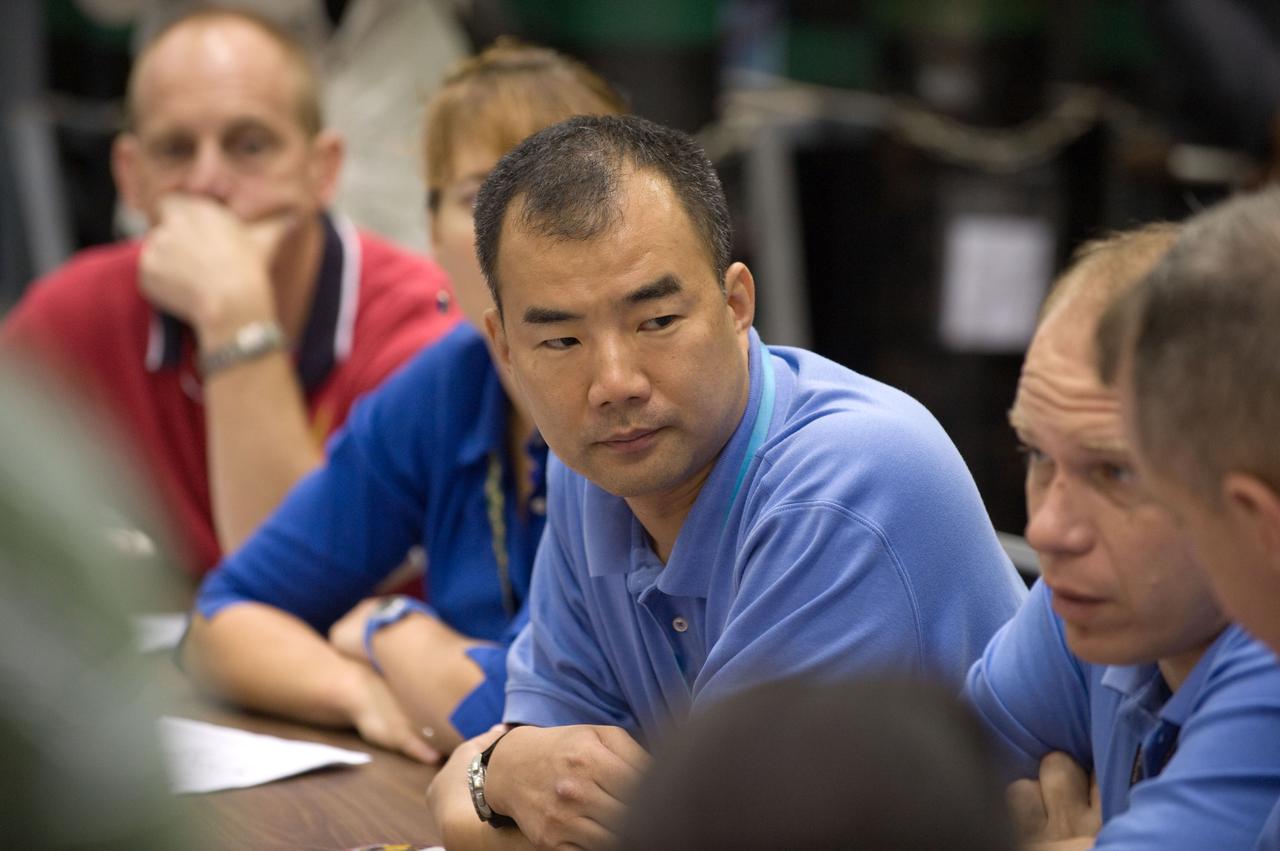 JSC2009-E-207891 (15 Sept. 2009) --- Japan Aerospace Exploration Agency (JAXA) astronaut Soichi Noguchi (center), Expedition 22/23 flight engineer; NASA astronauts Clay Anderson (background) and Dorothy Metcalf-Lindenburger, both STS-131 mission specialists; along with Russian cosmonaut Oleg Kotov (right), Expedition 22 flight engineer and Expedition 23 commander, participate in a training session in the Space Vehicle Mock-up Facility at NASA's Johnson Space Center.