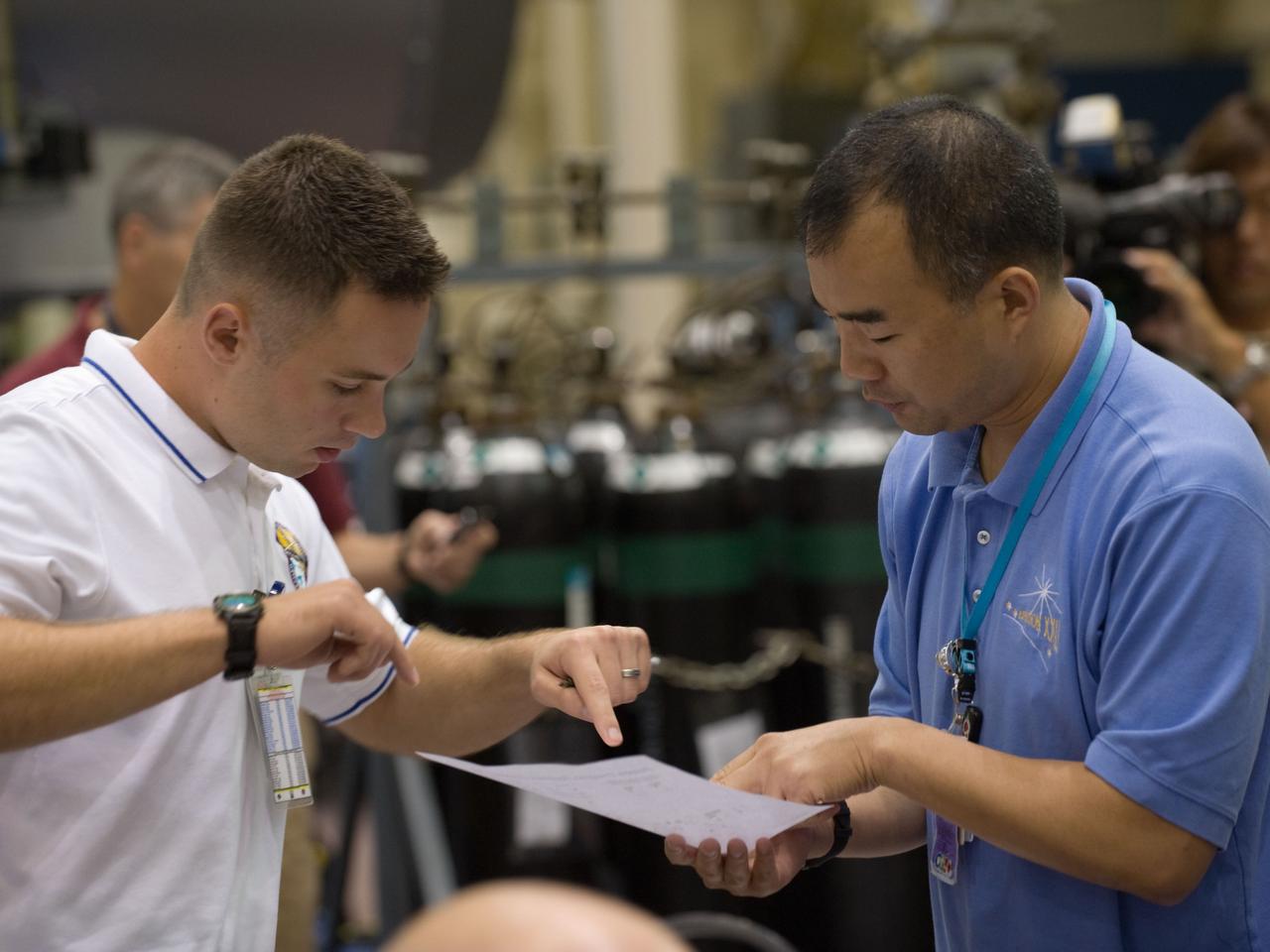 JSC2009-E-207892 (15 Sept. 2009) --- Japan Aerospace Exploration Agency (JAXA) astronaut Soichi Noguchi (right), Expedition 22/23 flight engineer, participates in a training session in the Space Vehicle Mock-up Facility at NASA's Johnson Space Center.