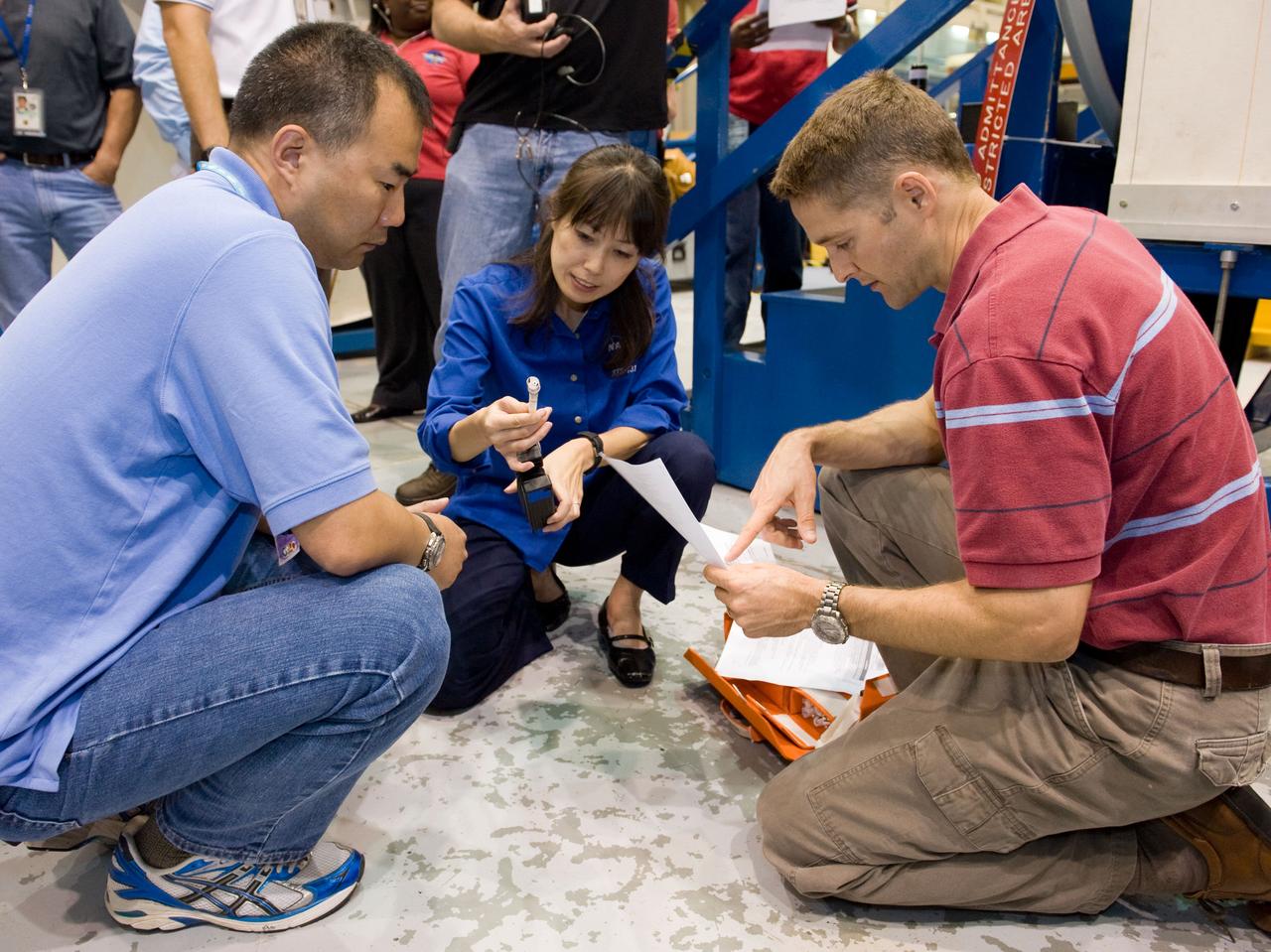 JSC2009-E-207894 (15 Sept. 2009) --- Japan Aerospace Exploration Agency (JAXA) astronauts Soichi Noguchi (left), Expedition 22/23 flight engineer; and Naoko Yamazaki, STS-131 mission specialist; along with NASA astronaut James P. Dutton Jr., STS-131 pilot, participate in a training session in the Space Vehicle Mock-up Facility at NASA's Johnson Space Center.