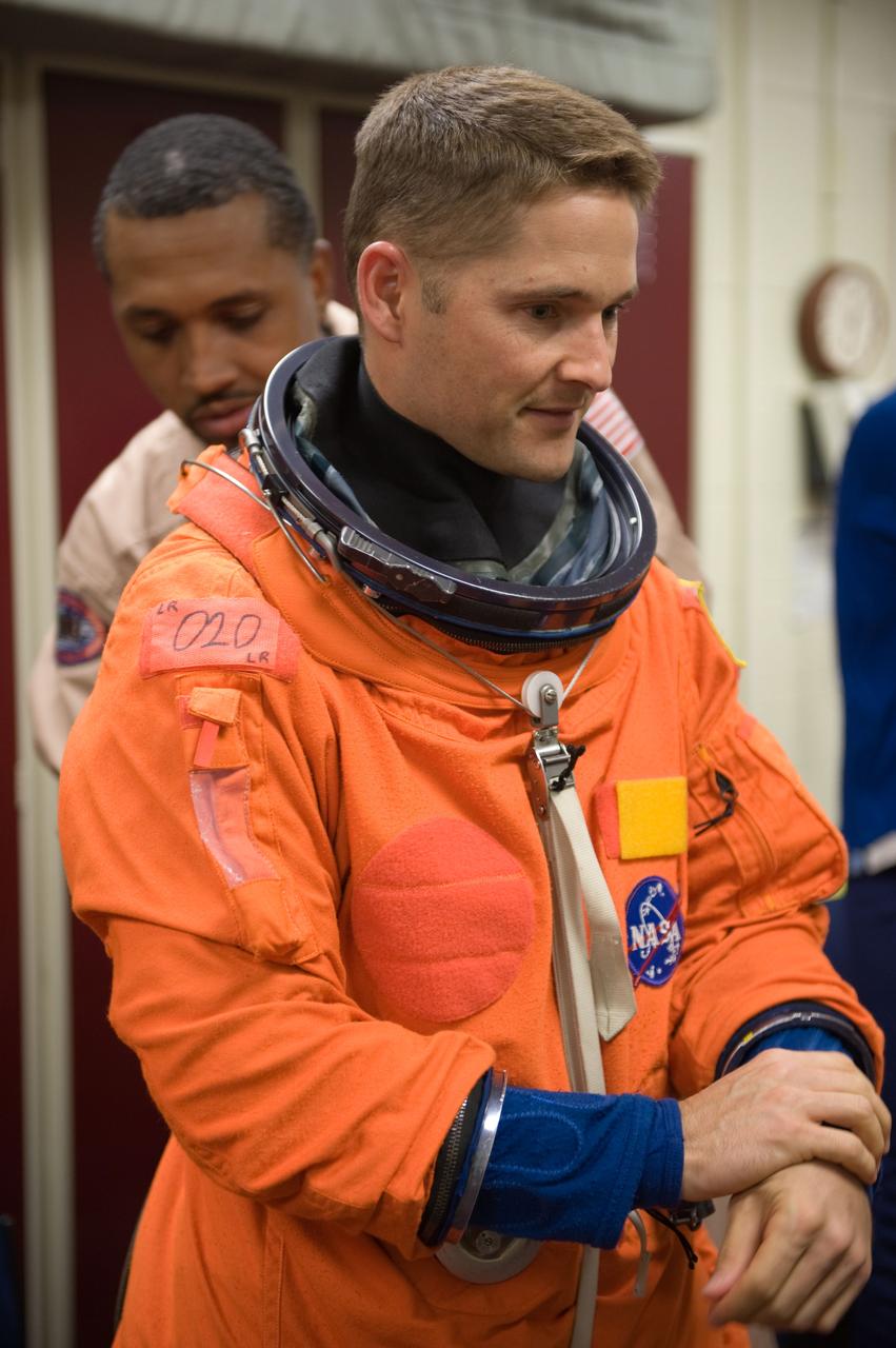 JSC2009-E-208003 (14 Sept. 2009) --- NASA astronaut James P. Dutton Jr., STS-131 pilot, dons a training version of his shuttle launch and entry suit in preparation for a training session in the Space Vehicle Mock-up Facility at NASA's Johnson Space Center.