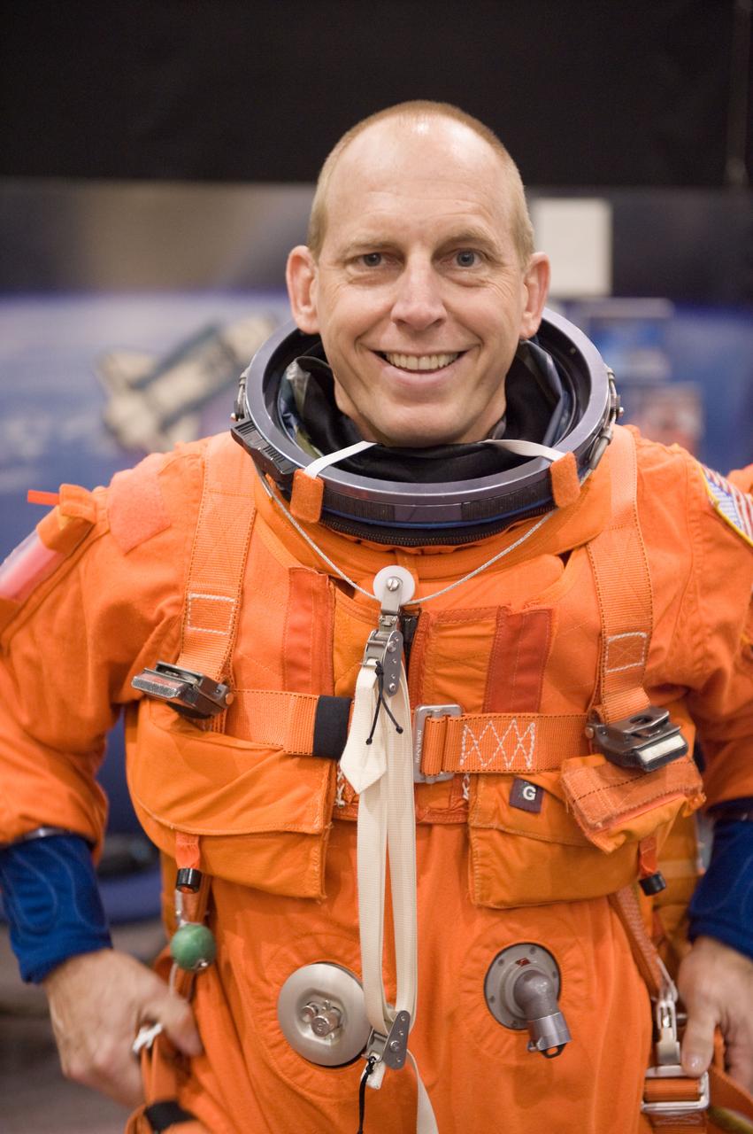 JSC2009-E-208016 (14 Sept. 2009) --- NASA astronaut Clay Anderson, STS-131 mission specialist, dons a training version of his shuttle launch and entry suit in preparation for a training session in the Space Vehicle Mock-up Facility at NASA's Johnson Space Center.