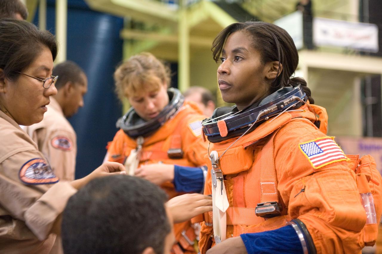 JSC2009-E-208023 (14 Sept. 2009) --- NASA astronaut Stephanie Wilson, STS-131 mission specialist, dons a training version of her shuttle launch and entry suit in preparation for a training session in the Space Vehicle Mock-up Facility at NASA's Johnson Space Center.