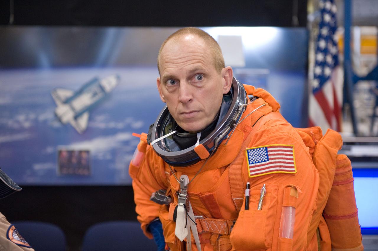 JSC2009-E-208025 (14 Sept. 2009) --- NASA astronaut Clay Anderson, STS-131 mission specialist, dons a training version of his shuttle launch and entry suit in preparation for a training session in the Space Vehicle Mock-up Facility at NASA's Johnson Space Center.