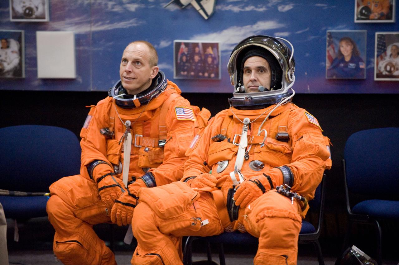JSC2009-E-208052 (14 Sept. 2009) --- Attired in training versions of their shuttle launch and entry suits, NASA astronauts Clay Anderson (left) and Rick Mastracchio, both STS-131 mission specialists, await the start of a training session in the Space Vehicle Mock-up Facility at NASA's Johnson Space Center.