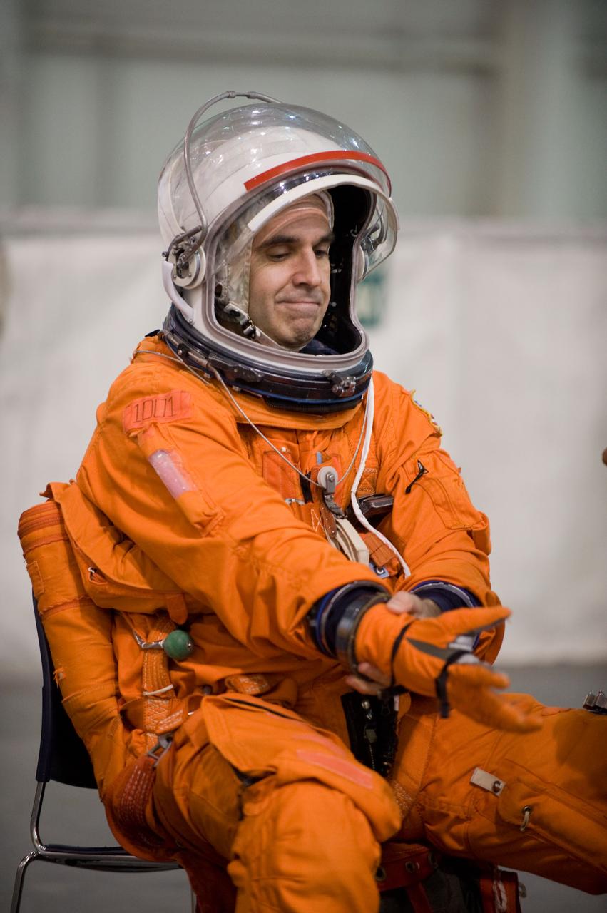 JSC2009-E-208940 (17 Sept. 2009) --- NASA astronaut Rick Mastracchio, STS-131 mission specialist, dons a training version of his shuttle launch and entry suit in preparation for a water survival training session in the Neutral Buoyancy Laboratory (NBL) near NASA's Johnson Space Center.