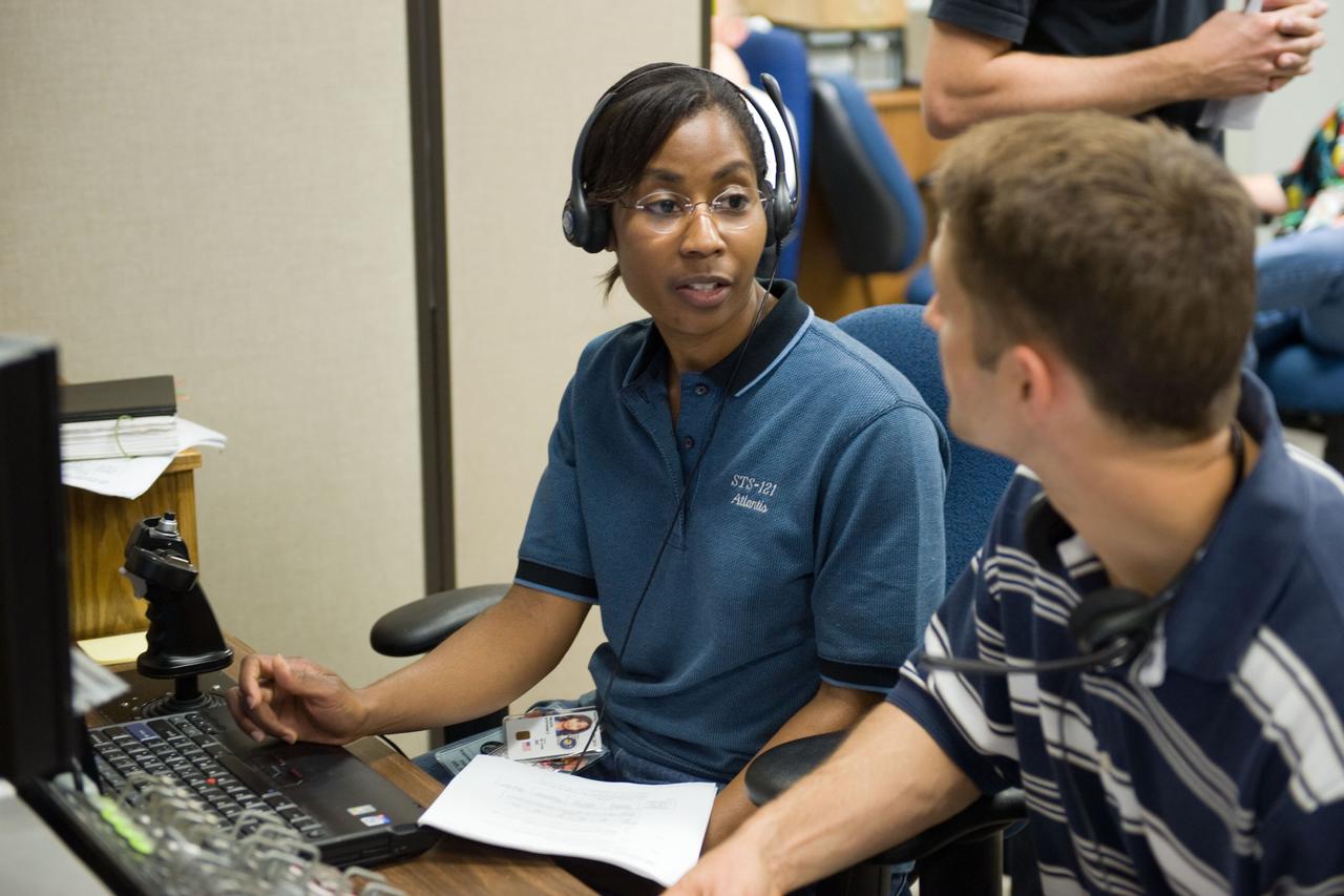 JSC2009-E-214321 (25 Sept. 2009) --- NASA astronauts James P. Dutton Jr., STS-131 pilot; and Stephanie Wilson, mission specialist, use the virtual reality lab in the Space Vehicle Mock-up Facility at NASA's Johnson Space Center to train for some of their duties aboard the space shuttle and space station. This type of computer interface, paired with virtual reality training hardware and software, helps to prepare the entire team for dealing with space station elements.