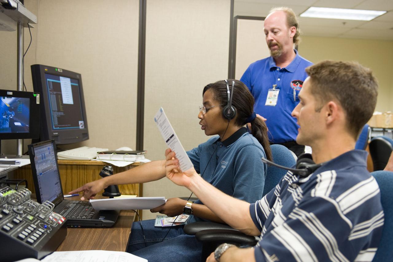 JSC2009-E-214322 (25 Sept. 2009) --- NASA astronauts James P. Dutton Jr., STS-131 pilot; and Stephanie Wilson, mission specialist, use the virtual reality lab in the Space Vehicle Mock-up Facility at NASA's Johnson Space Center to train for some of their duties aboard the space shuttle and space station. This type of computer interface, paired with virtual reality training hardware and software, helps to prepare the entire team for dealing with space station elements. United Space Alliance crew instructor Stephan Kinstle (background) assisted the crew members.
