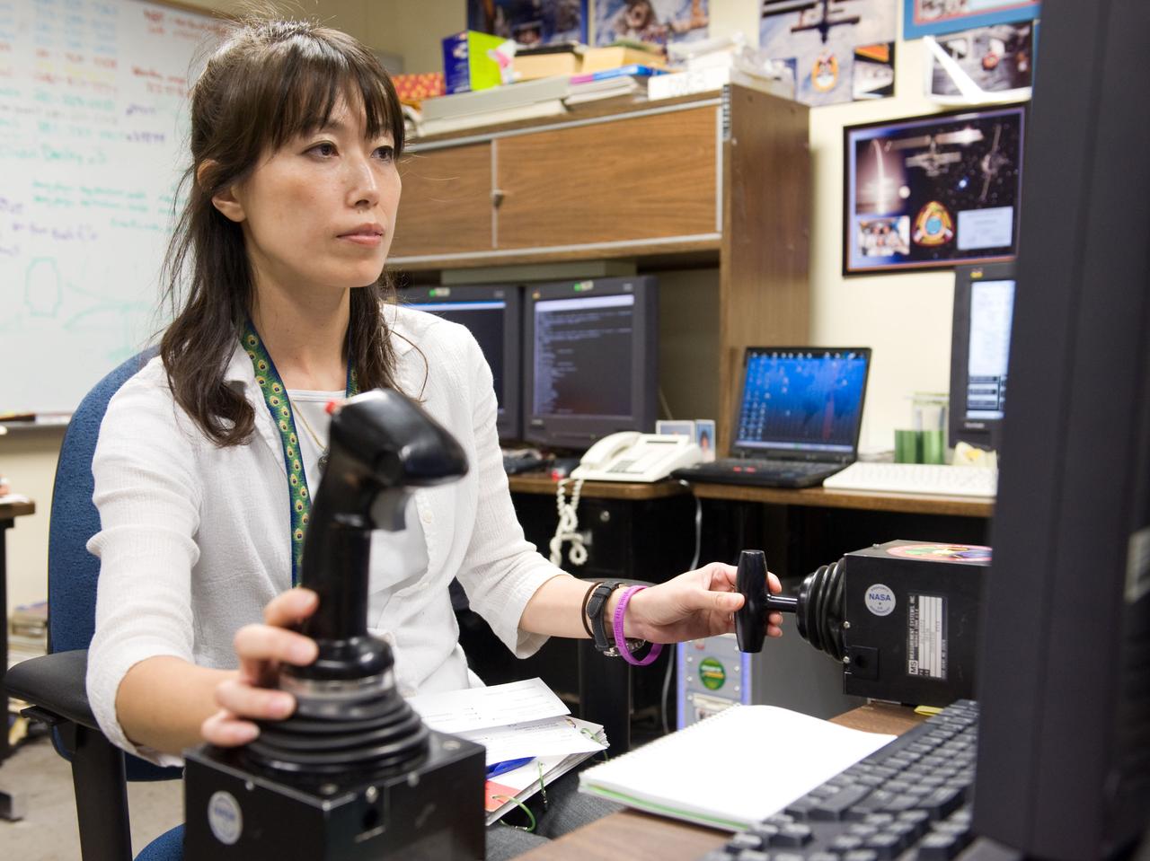 JSC2009-E-214346 (25 Sept. 2009) --- Japan Aerospace Exploration Agency (JAXA) astronaut Naoko Yamazaki, STS-131 mission specialist, uses the virtual reality lab in the Space Vehicle Mock-up Facility at NASA's Johnson Space Center to train for some of her duties aboard the space shuttle and space station. This type of computer interface, paired with virtual reality training hardware and software, helps to prepare the entire team for dealing with space station elements.