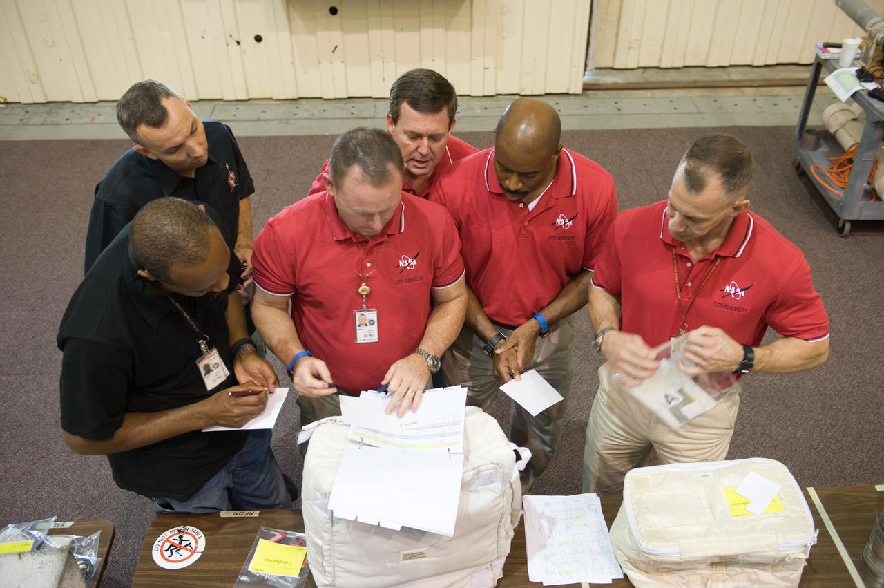 PHOTO DATE:  09-28-09 LOCATION:  Bldg 9NW, ISS Mockups SUBJECT:   STS-129 crew during trans hands-on review in the space station mockups. PHOTOGRAPHER:  James Blair