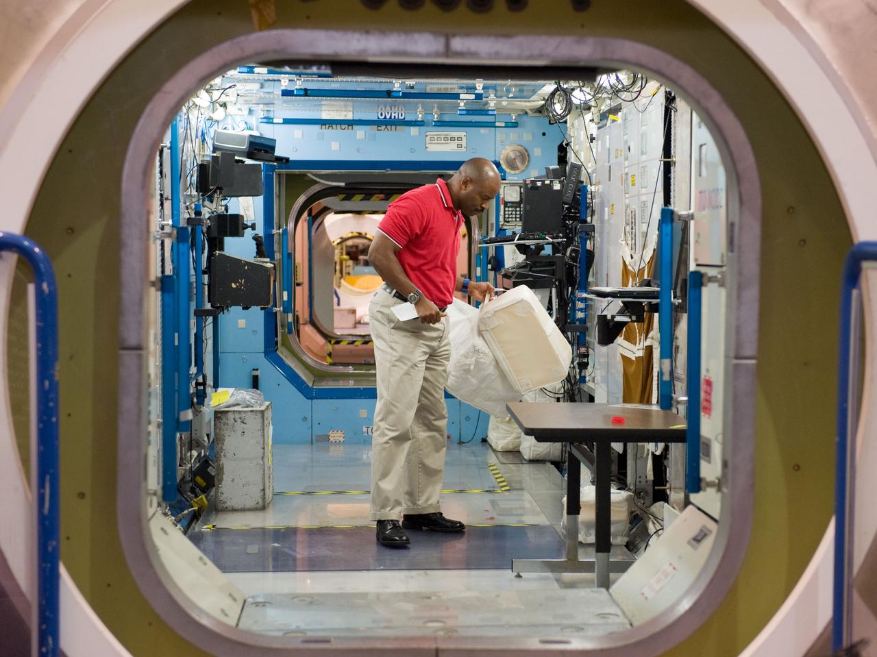 PHOTO DATE:  09-28-09 LOCATION:  Bldg 9NW, ISS Mockups SUBJECT:   STS-129 crew during trans hands-on review in the space station mockups. PHOTOGRAPHER:  James Blair
