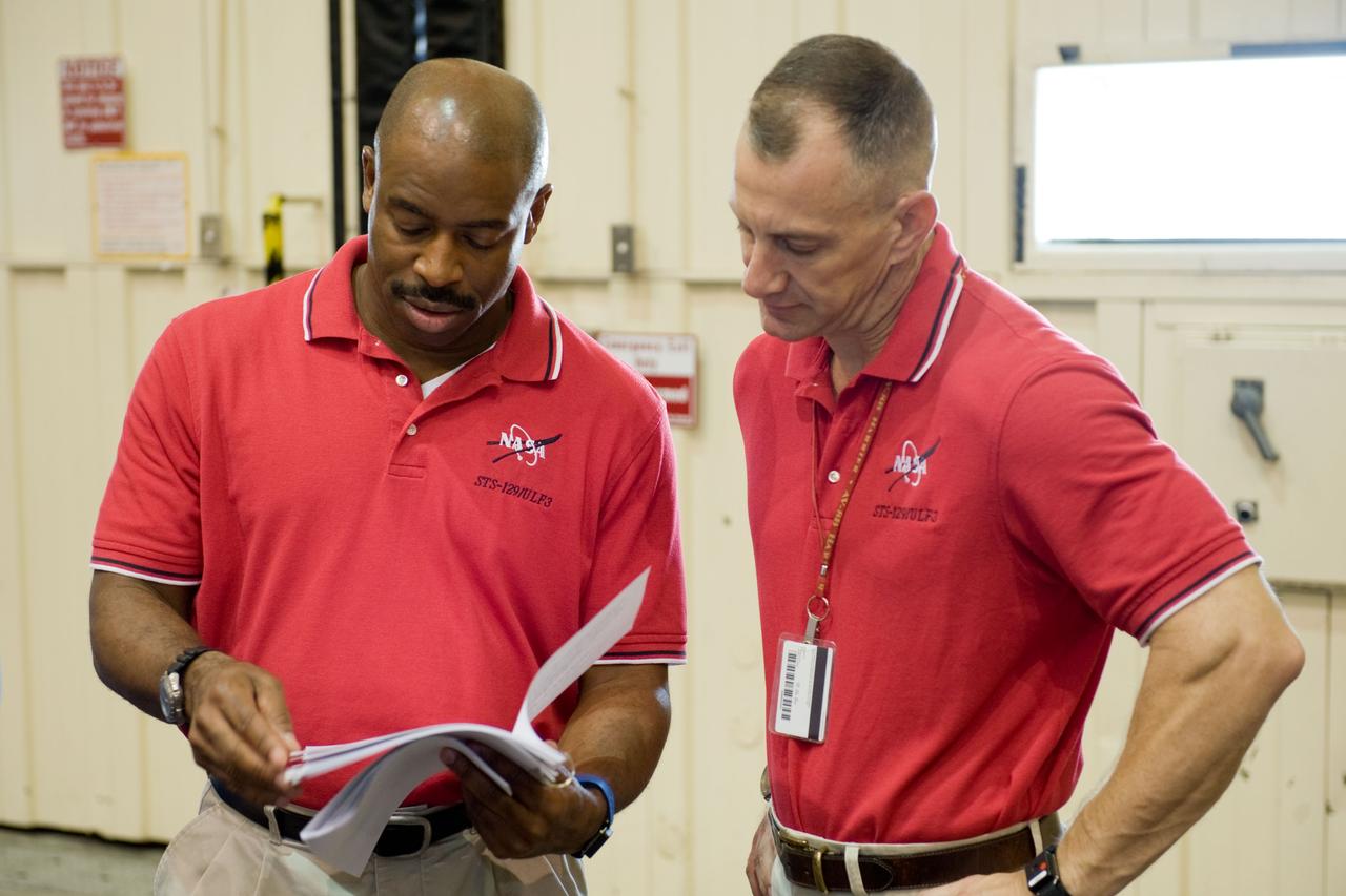 PHOTO DATE:  09-28-09 LOCATION:  Bldg 9NW, ISS Mockups SUBJECT:   STS-129 crew during trans hands-on review in the space station mockups. PHOTOGRAPHER:  James Blair