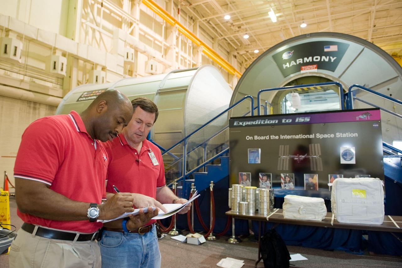 PHOTO DATE:  09-28-09 LOCATION:  Bldg 9NW, ISS Mockups SUBJECT:   STS-129 crew during trans hands-on review in the space station mockups. PHOTOGRAPHER:  James Blair
