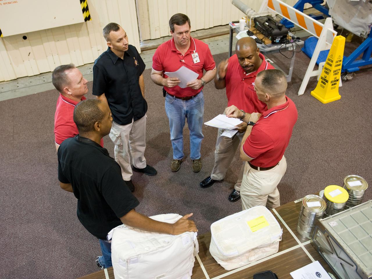 PHOTO DATE:  09-28-09 LOCATION:  Bldg 9NW, ISS Mockups SUBJECT:   STS-129 crew during trans hands-on review in the space station mockups. PHOTOGRAPHER:  James Blair