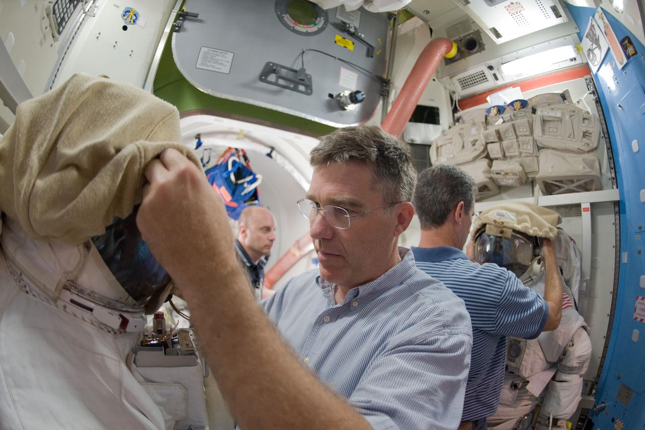 JSC2009-E-214811 (29 Sept. 2009) --- Astronauts Steve Bowen (foreground), Mike Good (right background) and Garrett Reisman, all STS-132 mission specialists, participate in a training session in an International Space Station mock-up/trainer in the Space Vehicle Mock-up Facility at NASA's Johnson Space Center.