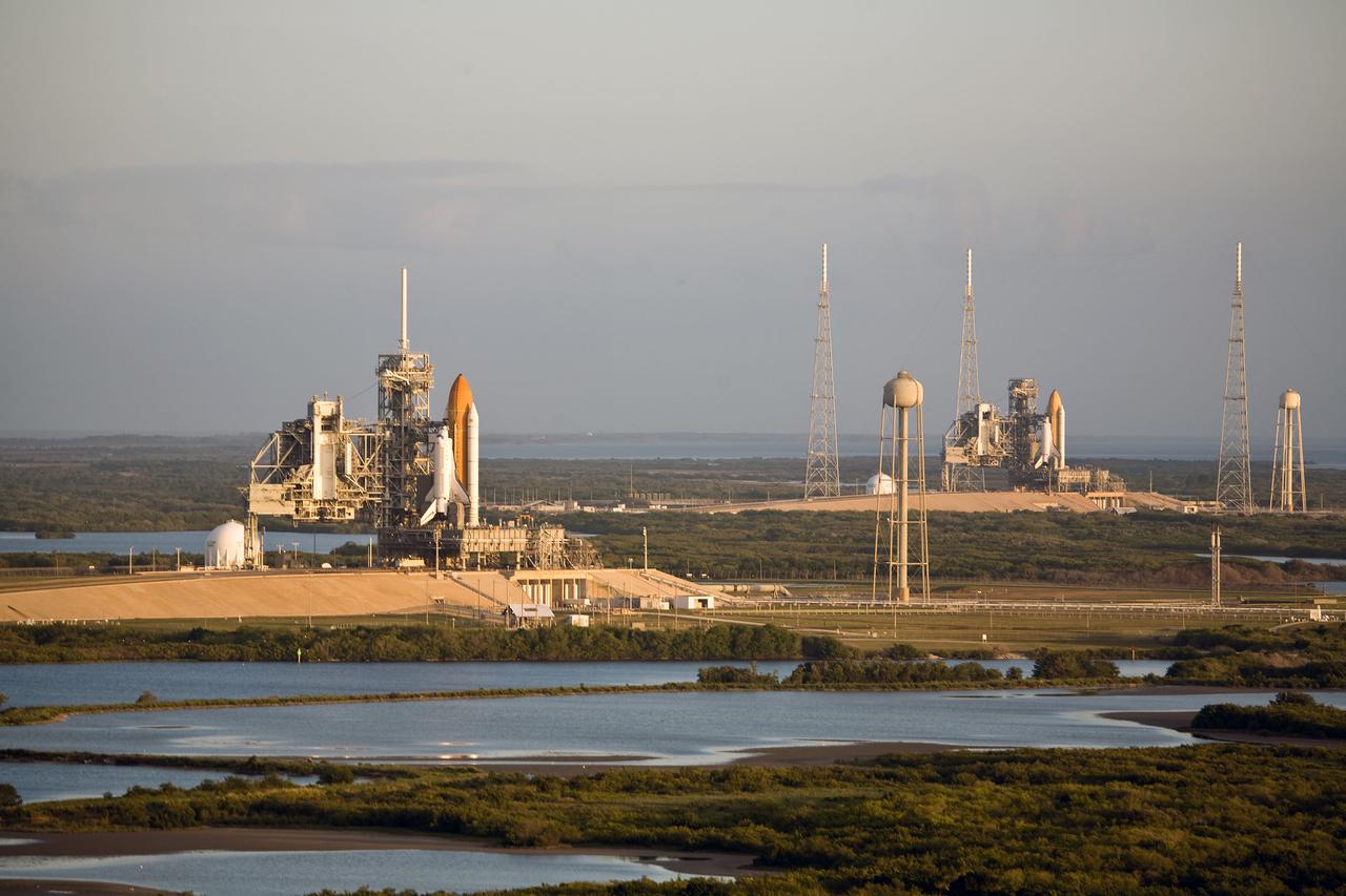 Space shuttle Atlantis (left) and space shuttle Endeavour are seen on Launch Pads 39A and 39B, respectively, at NASA's Kennedy Space Center in Florida. This is probably the final time two shuttles will be on launch pads at the same time with the space shuttle fleet set for retirement in 2010. Surrounding pad 39B are the lightning towers erected for NASA's Constellation Program, which will use the pad for Ares rocket launches. Endeavour will be prepared on the pad for liftoff in the unlikely event that a rescue mission is necessary following space shuttle Atlantis' launch on the STS-125 mission to service NASA's Hubble Space Telescope. After Atlantis is cleared to land, Endeavour will move to Launch Pad 39A for its upcoming STS-127 mission to the International Space Station, targeted to launch June 13. Original photo number is KSC-2009-2771.