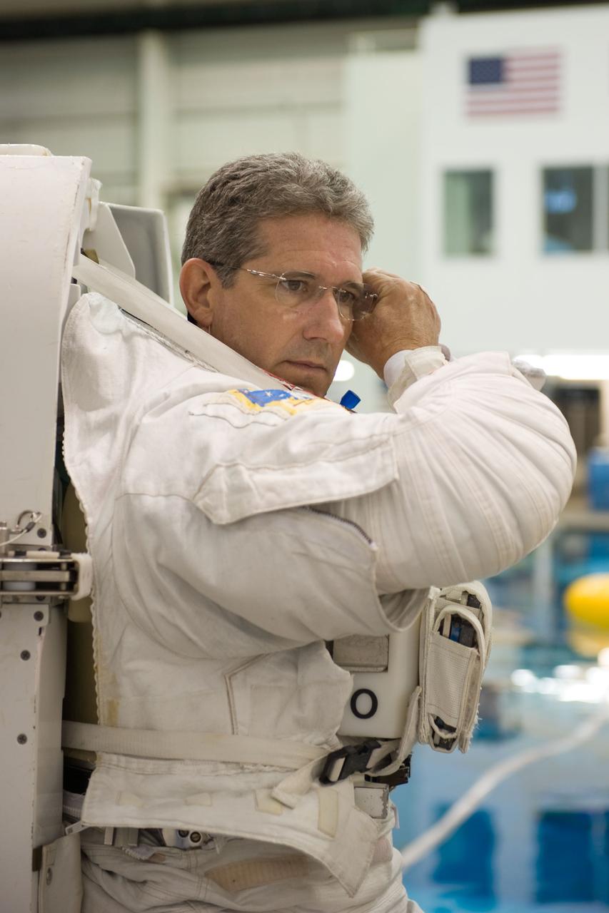 JSC2009-E-215152 (30 Sept. 2009) --- Astronaut Mike Good, STS-132 mission specialist, dons a training version of his Extravehicular Mobility Unit (EMU) spacesuit in preparation for a spacewalk training session in the waters of the Neutral Buoyancy Laboratory (NBL) near NASA's Johnson Space Center.