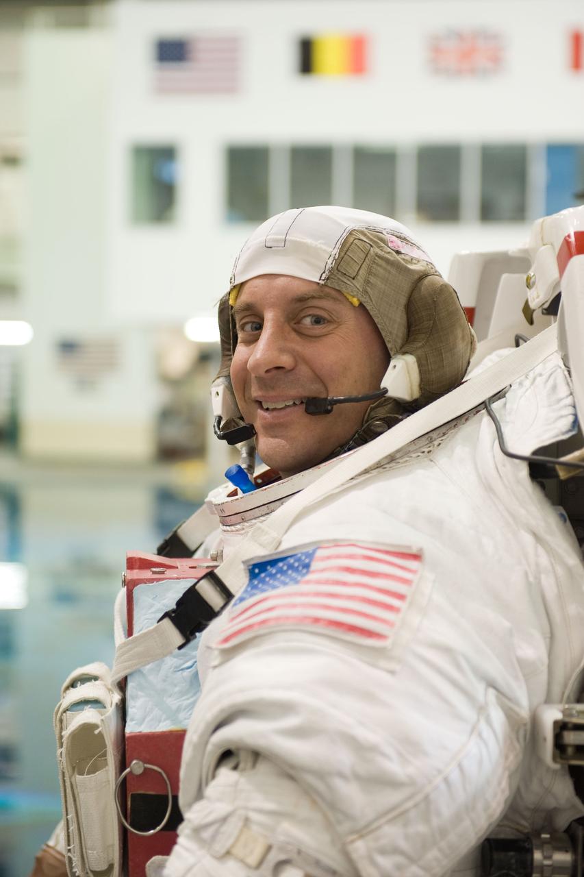 JSC2009-E-215153 (30 Sept. 2009) --- Attired in a training version of his Extravehicular Mobility Unit (EMU) spacesuit, astronaut Garrett Reisman, STS-132 mission specialist, awaits the start of a spacewalk training session in the waters of the Neutral Buoyancy Laboratory (NBL) near NASA's Johnson Space Center.