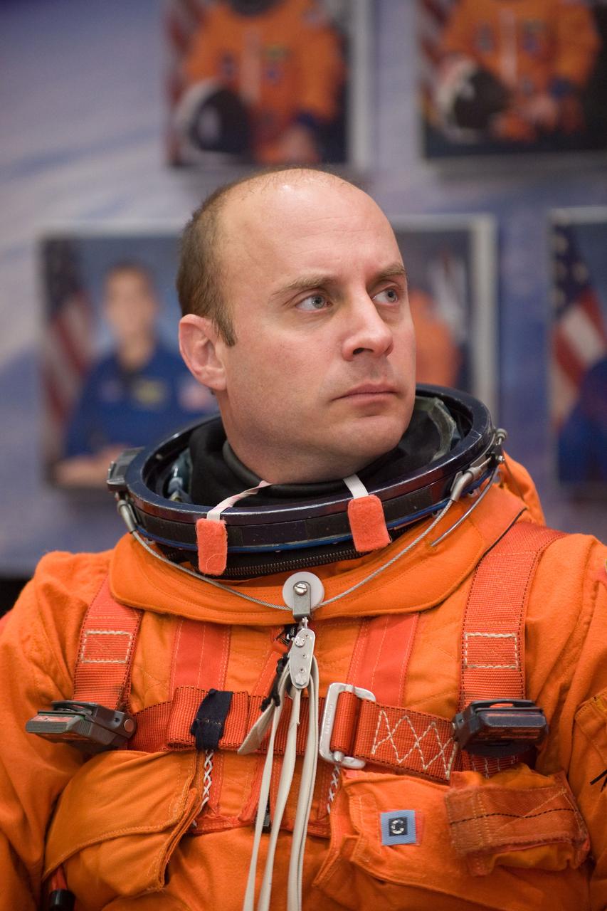 JSC2009-E-224126 (20 Oct. 2009) --- Astronaut Garrett Reisman, STS-132 mission specialist, attired in a training version of his shuttle launch and entry suit, awaits the start of a training session in the Space Vehicle Mock-up Facility at NASA?s Johnson Space Center.