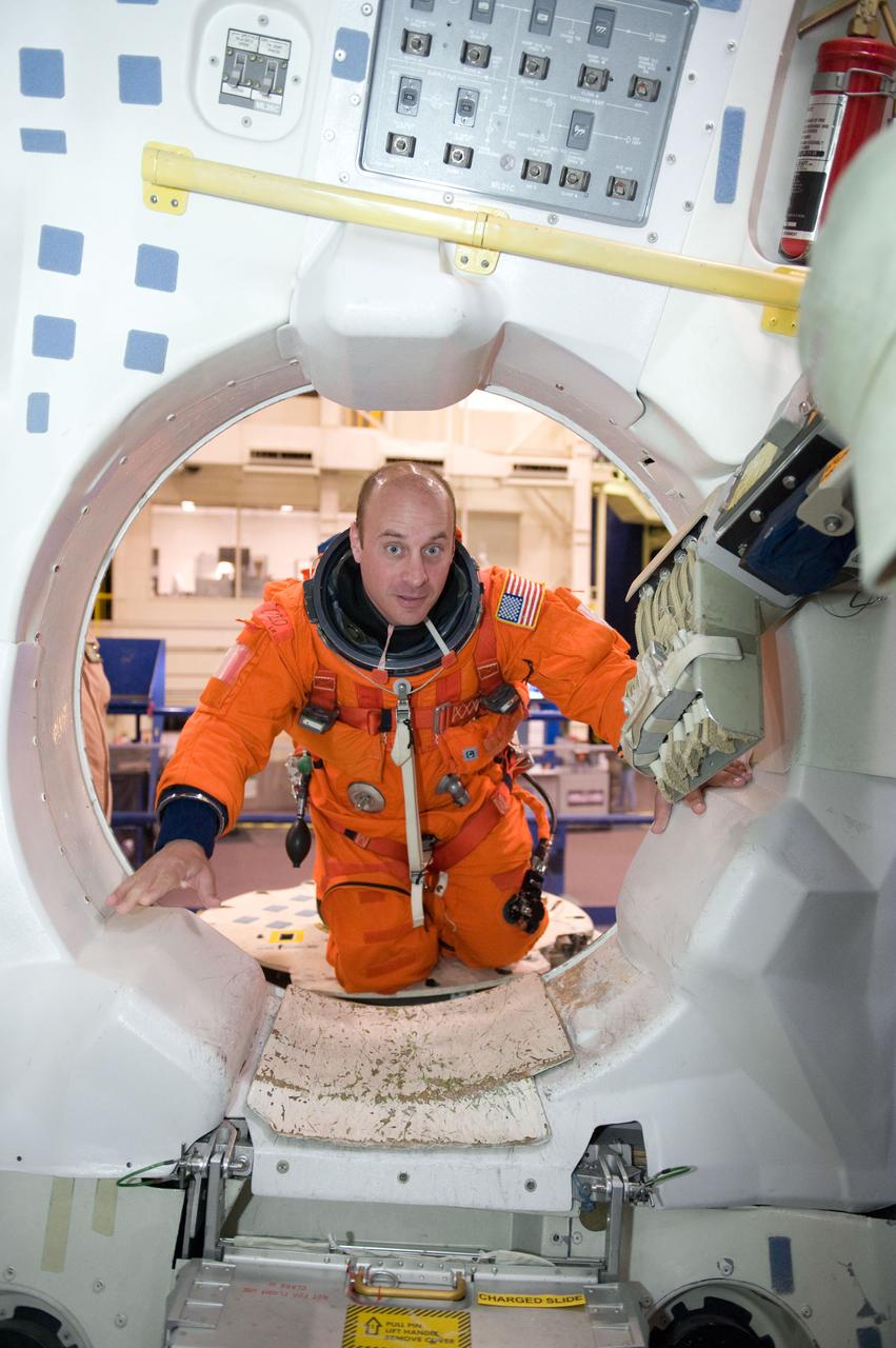 JSC2009-E-224138 (20 Oct. 2009) --- Astronaut Garrett Reisman, STS-132 mission specialist, attired in a training version of his shuttle launch and entry suit, participates in a training session in the Space Vehicle Mock-up Facility at NASA?s Johnson Space Center.