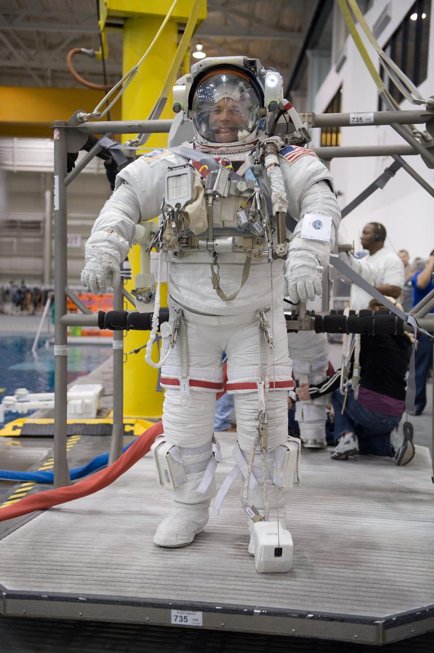 JSC2009-E-226231 (28 Oct. 2009) --- Attired in a training version of his Extravehicular Mobility Unit (EMU) spacesuit, astronaut Doug Wheelock, Expedition 24 flight engineer and Expedition 25 commander, is about to be submerged in the waters of the Neutral Buoyancy Laboratory (NBL) near NASA's Johnson Space Center. Divers (out of frame) are in the water to assist Wheelock in his rehearsal, which is intended to help prepare him for work on the exterior of the International Space Station.