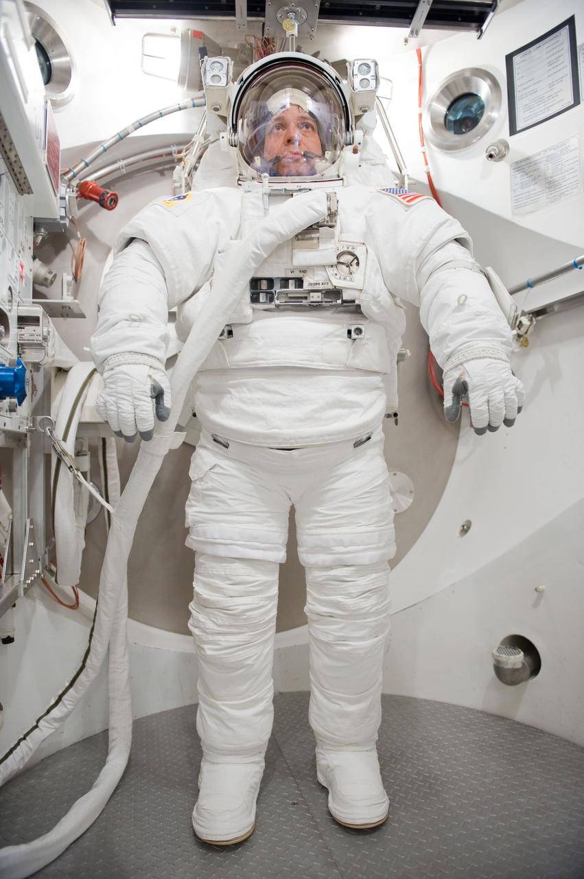 JSC2009-E-226283 (27 Oct. 2009) --- Astronaut Robert Behnken, STS-130 mission specialist, participates in an Extravehicular Mobility Unit (EMU) spacesuit fit check in the Space Station Airlock Test Article (SSATA) in the Crew Systems Laboratory at NASA's Johnson Space Center.