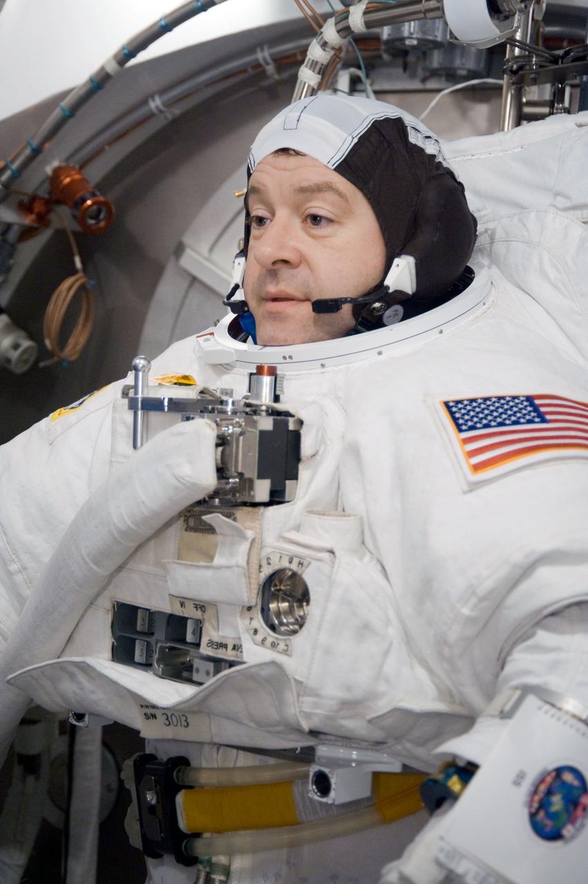 JSC2009-E-228743 (29 Oct. 2009) --- Astronaut Nicholas Patrick, STS-130 mission specialist, participates in an Extravehicular Mobility Unit (EMU) spacesuit fit check in the Space Station Airlock Test Article (SSATA) in the Crew Systems Laboratory at NASA's Johnson Space Center.