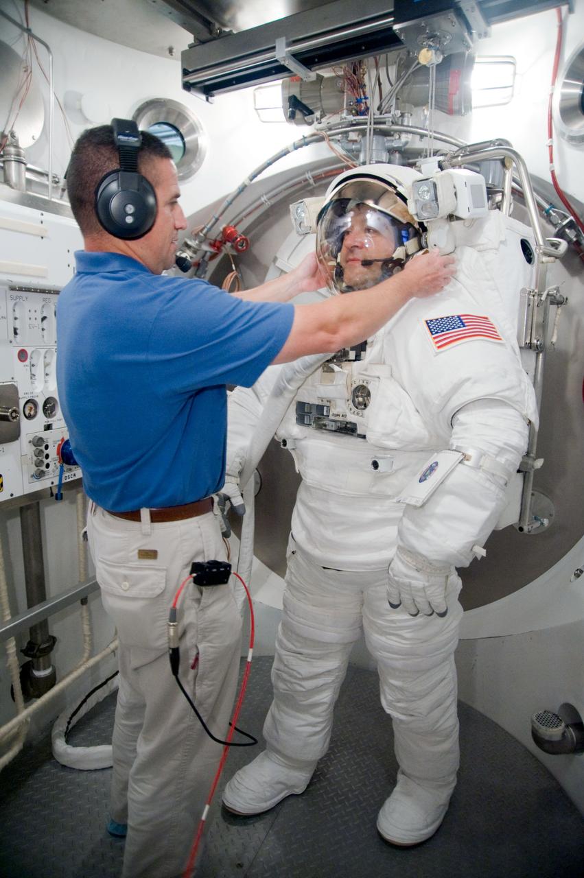 JSC2009-E-228757 (29 Oct. 2009) --- Astronaut Nicholas Patrick, STS-130 mission specialist, participates in an Extravehicular Mobility Unit (EMU) spacesuit fit check in the Space Station Airlock Test Article (SSATA) in the Crew Systems Laboratory at NASA's Johnson Space Center. Astronaut George Zamka, commander, assisted Patrick.