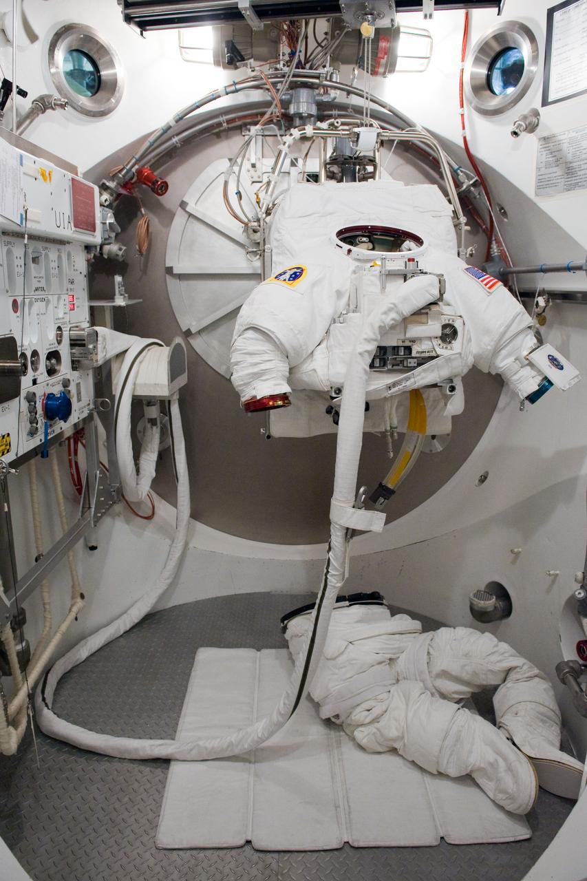 JSC2009-E-240471 (5 Nov. 2009) --- An empty Extravehicular Mobility Unit (EMU) spacesuit is photographed prior to a fit check with astronaut Clayton Anderson (out of frame), STS-131 mission specialist, in the Space Station Airlock Test Article (SSATA) in the Crew Systems Laboratory at NASA's Johnson Space Center.