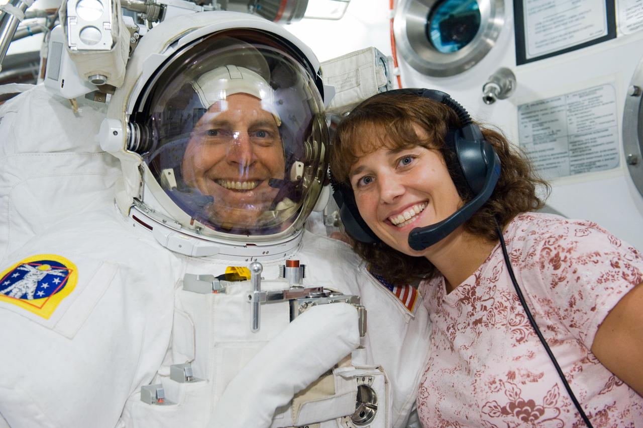 JSC2009-E-240528 (5 Nov. 2009) --- Astronaut Clayton Anderson, STS-131 mission specialist, participates in an Extravehicular Mobility Unit (EMU) spacesuit fit check in the Space Station Airlock Test Article (SSATA) in the Crew Systems Laboratory at NASA's Johnson Space Center. Astronaut Dorothy Metcalf-Lindenburger, mission specialist, assisted Anderson.