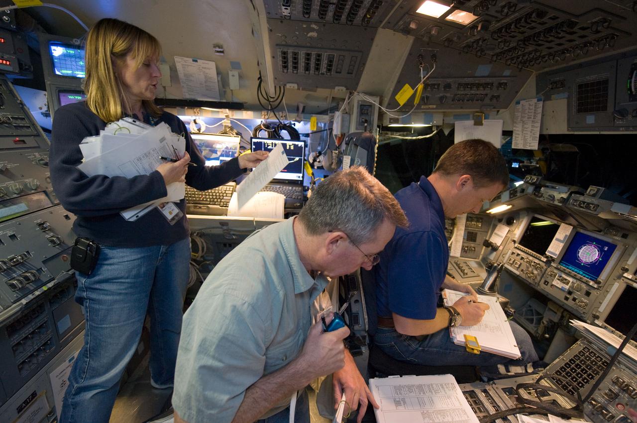 JSC2009-E-240771 (12 Nov. 2009) --- Astronauts Terry Virts (right), STS-130 pilot; Kathryn Hire and Stephen Robinson, both mission specialists, participate in a training session in the fixed-base shuttle mission simulator (SMS) in the Jake Garn Simulation and Training Facility at Johnson Space Center.