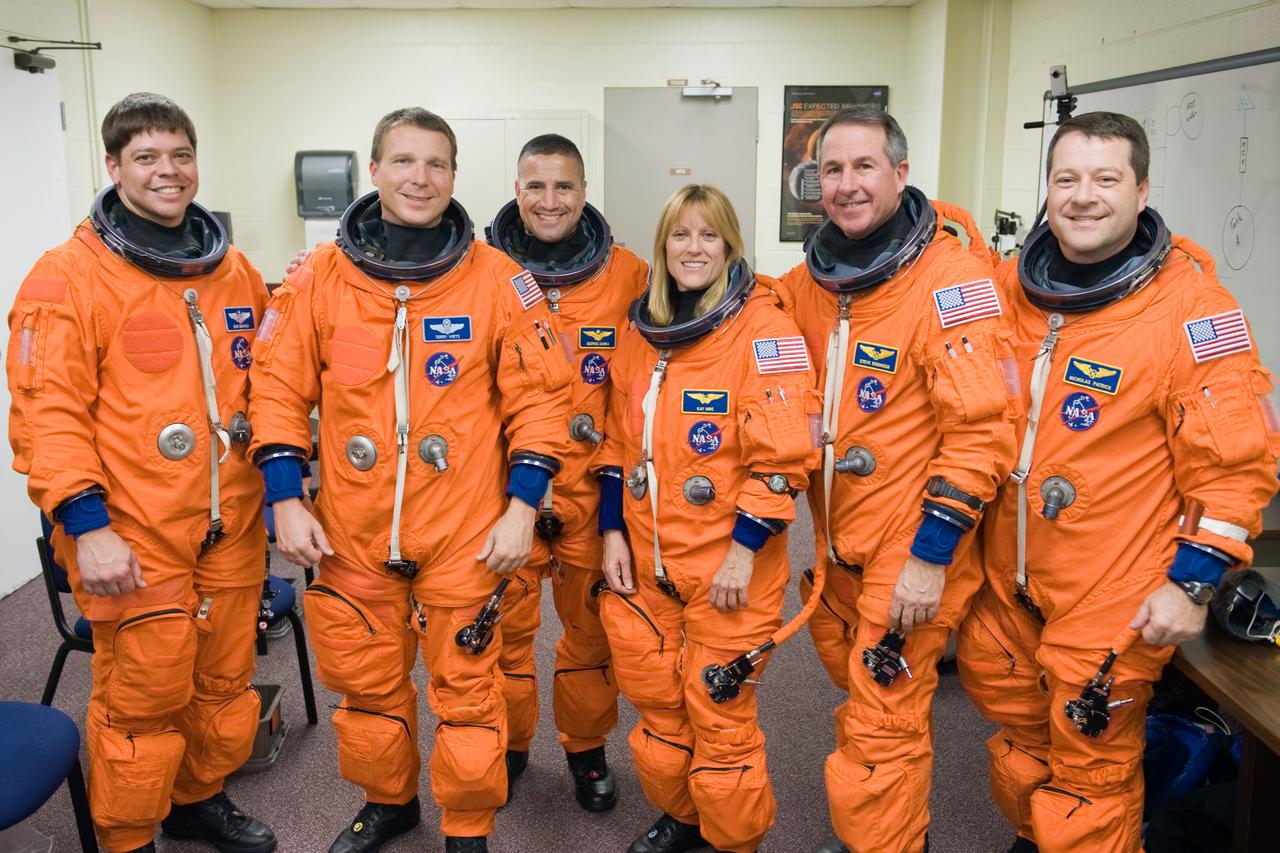 JSC2009-E-242826 (19 Nov. 2009) --- STS-130 crew members, attired in training versions of their shuttle launch and entry suits, pose for a photo prior to a training session in the Space Vehicle Mock-up Facility at NASA's Johnson Space Center. Pictured from the left are astronauts Robert Behnken, mission specialist; Terry Virts, pilot; George Zamka, commander; Kathryn Hire, Stephen Robinson and Nicholas Patrick, all mission specialists.