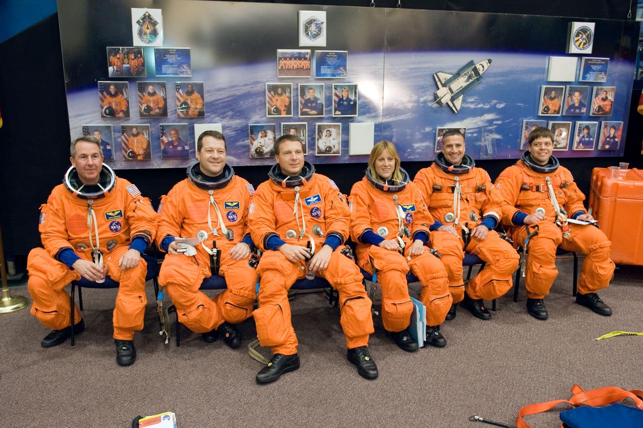 JSC2009-E-242833 (19 Nov. 2009) --- The STS-130 crew members, attired in training versions of their shuttle launch and entry suits, await the start of a training session in the Space Vehicle Mockup Facility at NASA's Johnson Space Center. From the left are astronauts Stephen Robinson and Nicholas Patrick, both mission specialists; Terry Virts, pilot; Kathryn Hire, mission specialist; George Zamka, commander; and Robert Behnken, mission specialist.