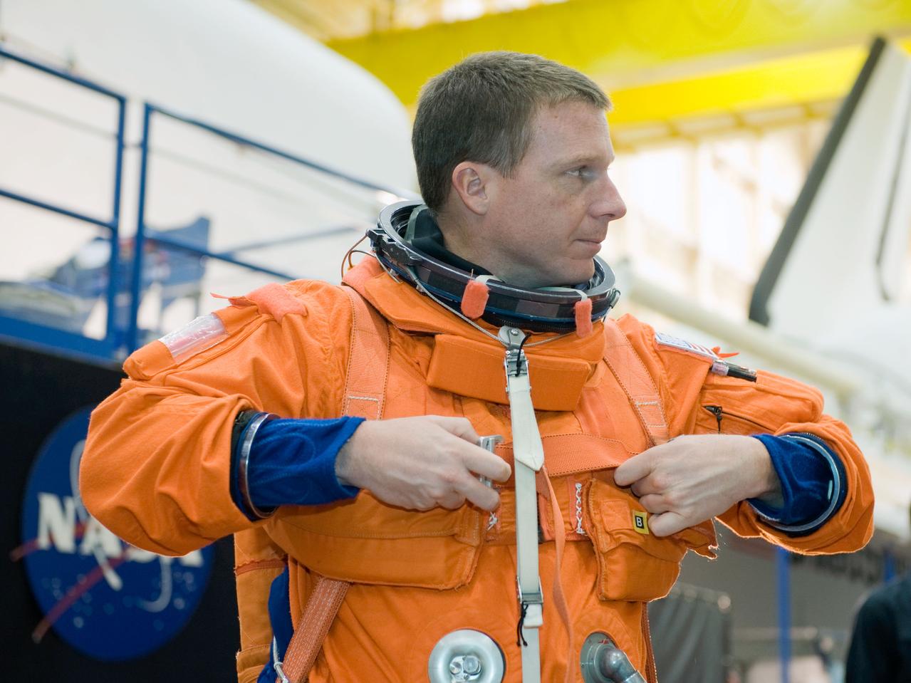 JSC2009-E-242836 (19 Nov. 2009) --- Astronaut Terry Virts, STS-130 pilot, dons a training version of his shuttle launch and entry suit in preparation for a training session in the Space Vehicle Mockup Facility at NASA's Johnson Space Center.