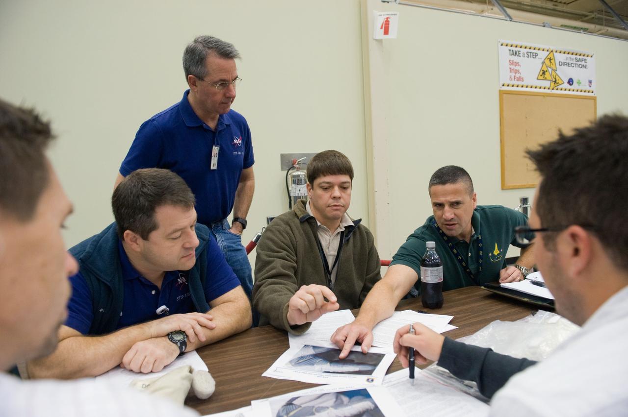 JSC2009-E-244192 (23 Nov. 2009) --- Astronaut George Zamka (right), STS-130 commander; along with astronauts Robert Behnken (center), Stephen Robinson (standing) and Nicholas Patrick, all mission specialists, participate in a training session in the Space Vehicle Mockup Facility at NASA's Johnson Space Center.