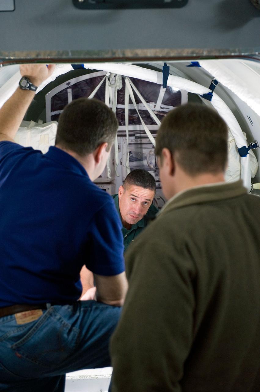 JSC2009-E-244214 (23 Nov. 2009) --- Astronaut George Zamka (background), STS-130 commander; along with astronauts Nicholas Patrick (left) and Robert Behnken, both mission specialists, participate in a training session in an International Space Station mock-up/trainer in the Space Vehicle Mock-up Facility at NASA's Johnson Space Center.