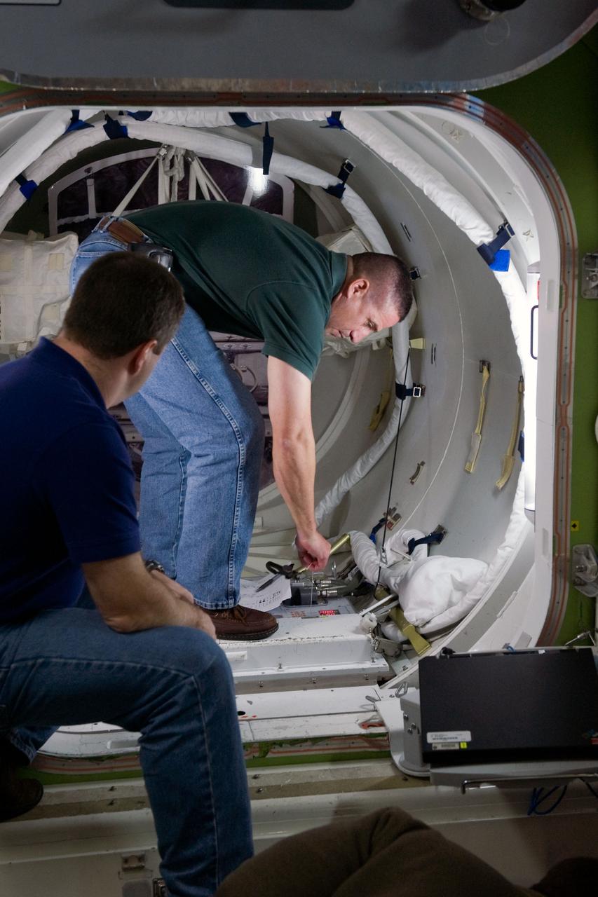 JSC2009-E-244218 (23 Nov. 2009) --- Astronaut George Zamka (background), STS-130 commander; and astronaut Nicholas Patrick, mission specialist, participate in a training session in an International Space Station mock-up/trainer in the Space Vehicle Mock-up Facility at NASA's Johnson Space Center.