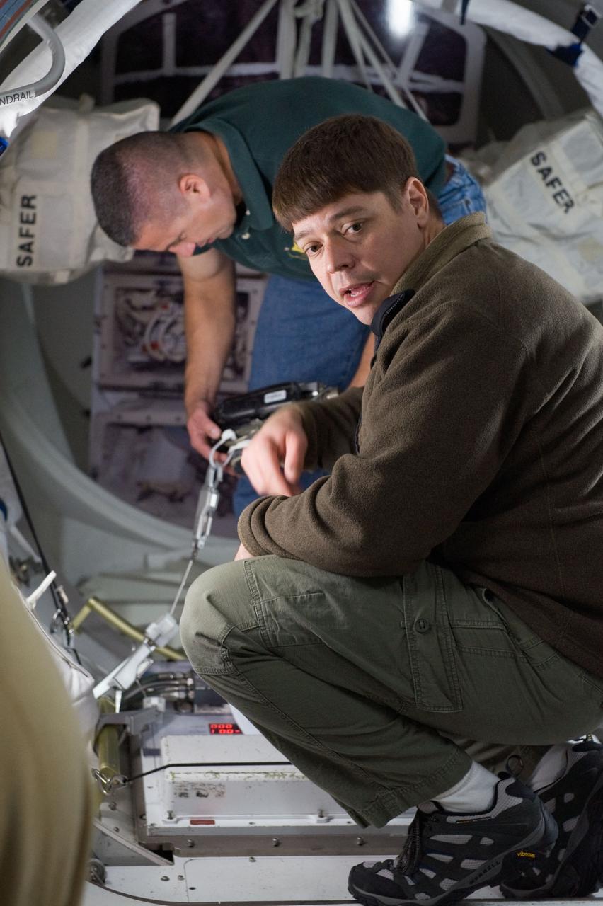 JSC2009-E-244223 (23 Nov. 2009) --- Astronaut George Zamka (background), STS-130 commander; and astronaut Robert Behnken, mission specialist, participate in a training session in an International Space Station mock-up/trainer in the Space Vehicle Mock-up Facility at NASA's Johnson Space Center.