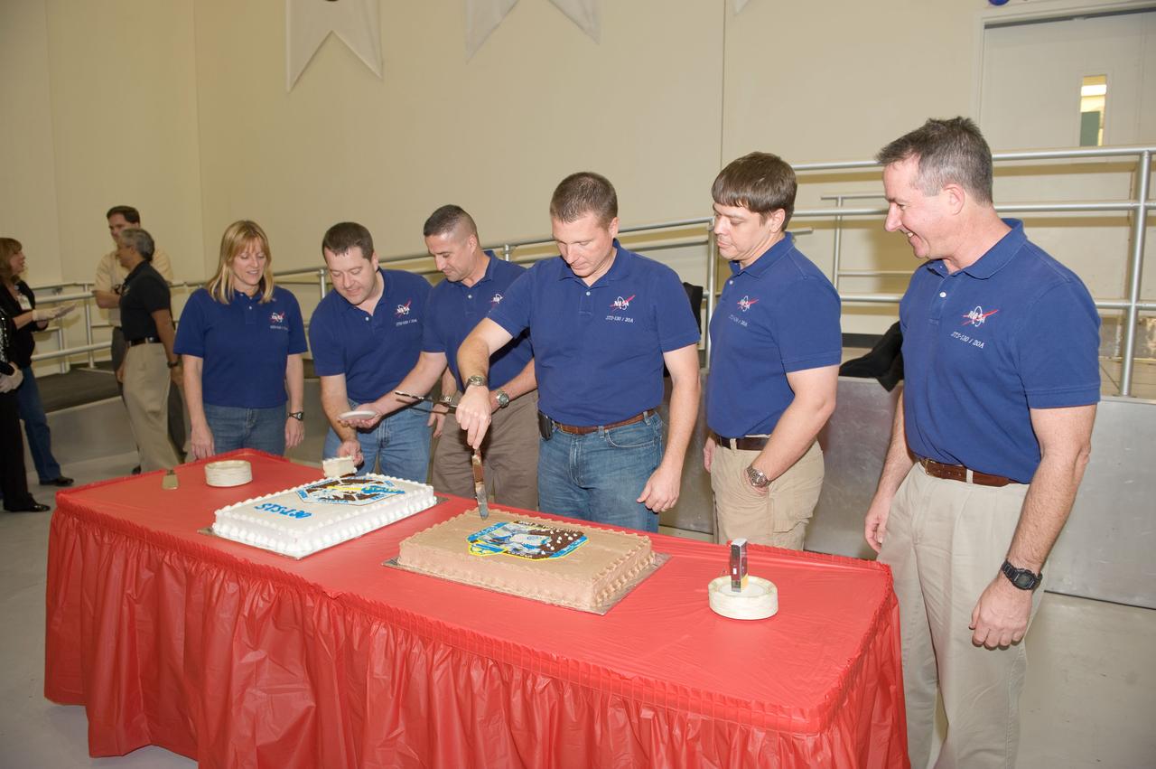 JSC2009-E-246198 (2 Dec. 2009) --- The STS-130 crew members are pictured at a cake-cutting ceremony in the Jake Garn Simulation and Training Facility at NASA's Johnson Space Center. Pictured from the left are astronauts Kathryn Hire, Nicholas Patrick, both mission specialists; George Zamka, commander; Terry Virts, pilot; Robert Behnken and Stephen Robinson, both mission specialists.